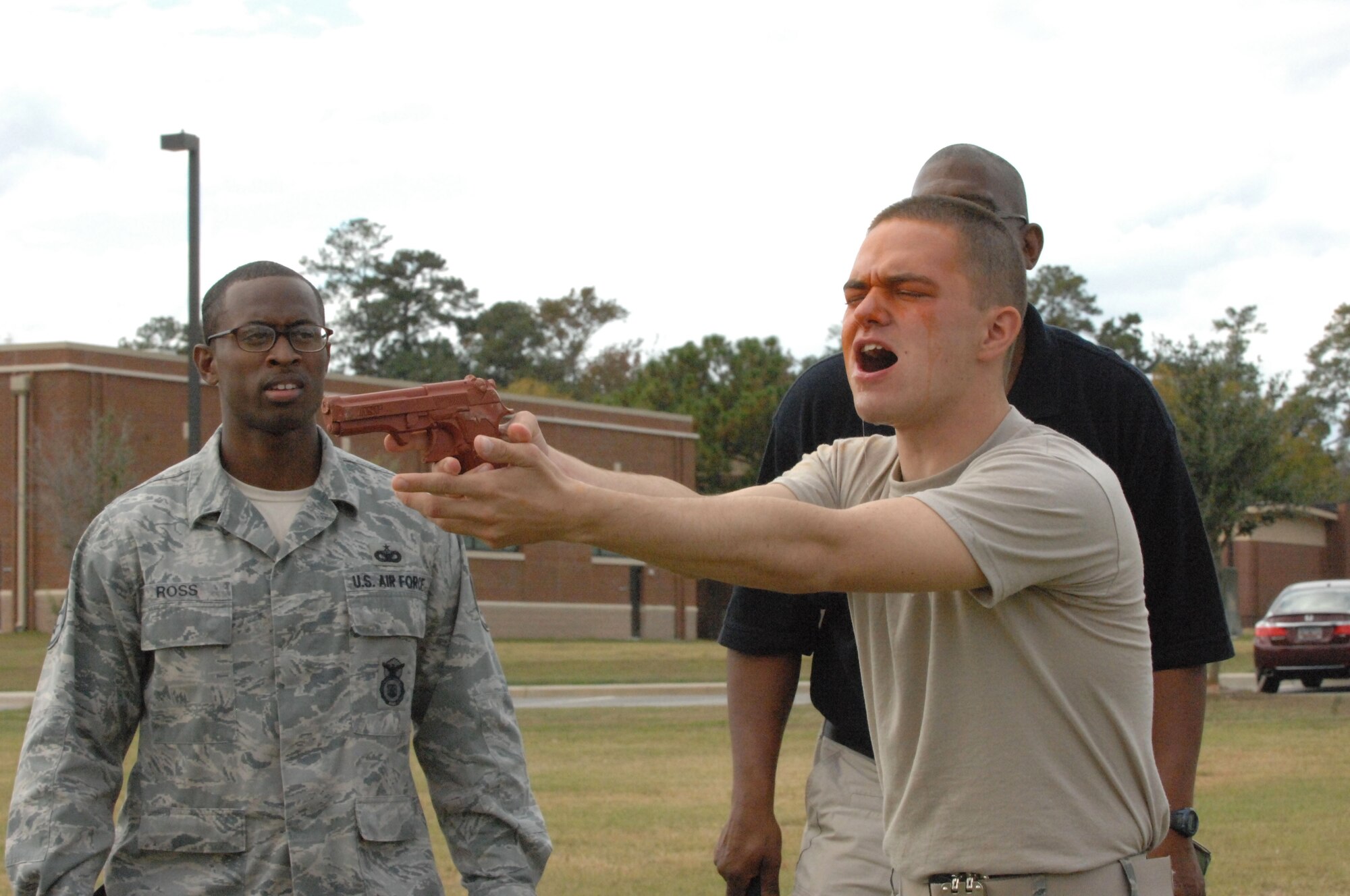 U.S. Air Force Airman 1st Class Samuel Garr, 20th Security Forces Squadron response force member, points a dummy gun as he practices attacking an enemy after being exposed to oleoresin capsicum pepper spray.  First term security forces Airmen must complete this training after arriving at their first duty station. (U.S. Air Force photo by Airman Nicole Sikorski/Released)