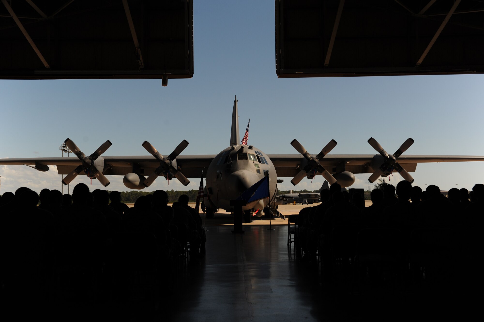 Airmen gather in front of an AC-130H Spooky gunship during a memorial ceremony for a fallen 1st Special Operations Aircraft Maintenance Squadron Airman at the Commando Hangar at Hurlburt Field, Oct. 25, 2012. Airman 1st Class Colby Graham Siegel, an aerospace propulsion apprentice with 1st SOAMXS, passed away Oct. 21, 2012 during a boating mishap in the Santa Rosa Sound, Fla. (U.S. Air Force photo / Senior Airman Eboni Reams)(Released)