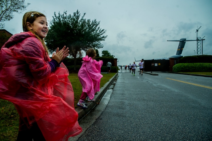 Kinsley Bordeaux, daughter of Master Sgt. Harold Bordeaux, 16th Airlift Squadron loadmaster superintendent, directs runners during the fourth annual Run the Runway 5K event honoring retired Brig. Gen. Thomas Mikolajcik Oct. 27, 2012, at Joint Base Charleston - Air Base, S.C. The 437th Airlift Wing hosted the event which was open to all military, Department of Defense civilians and the local community. (U.S. Air Force photo/ Airman 1st Class George Goslin)