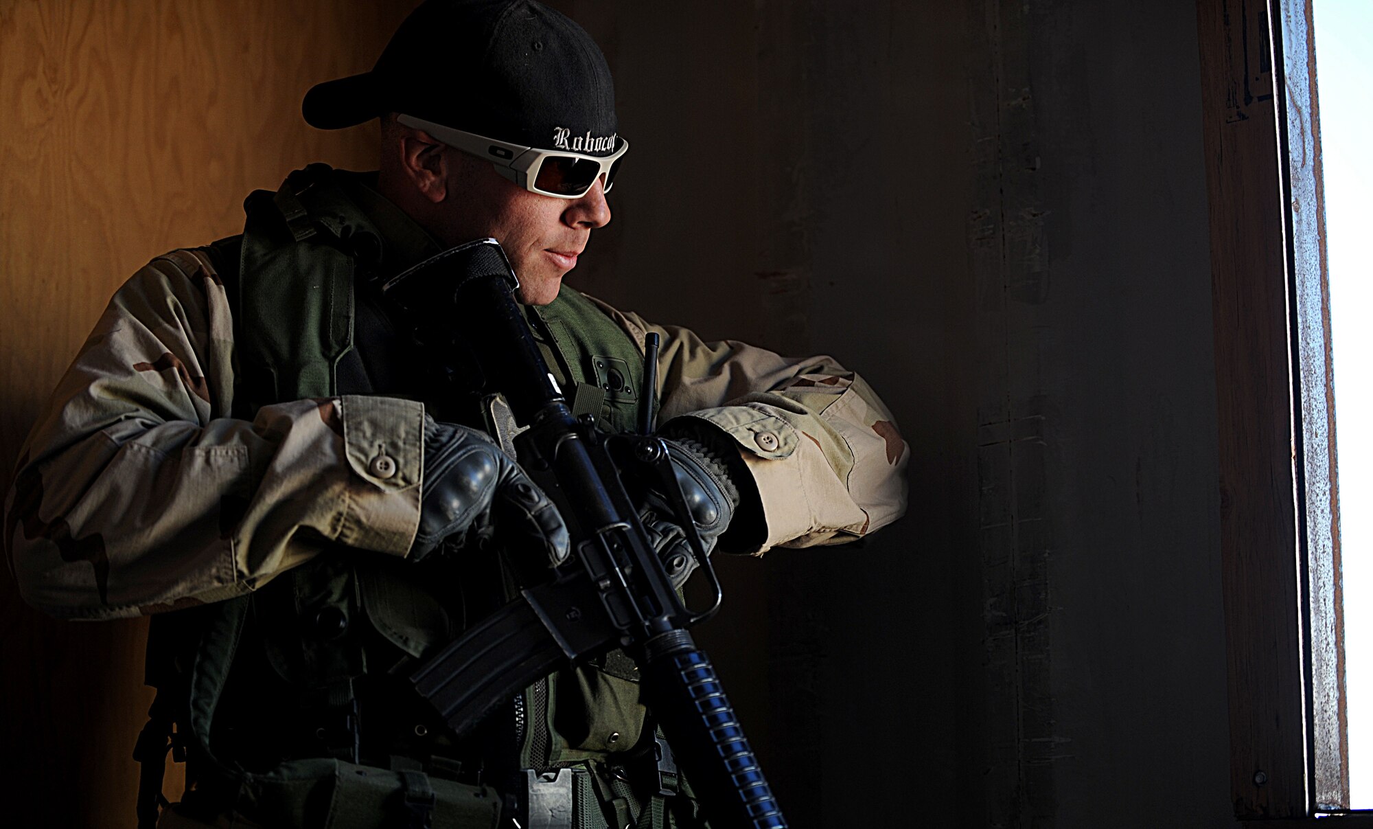 Staff Sgt. T.J. Lombardi, 341st Security Forces Group NCO-in charge of equipment, prepares to radio his status and position during the Road Warrior exercise at Camp Guernsey, Wyo., Oct. 20, 2012. Lombardi played in the exercise as an opposing force team member charged with stealing a nuclear resource from a convoy. (U.S. Air Force photo by Senior Airman Jarad A. Denton/Released)
