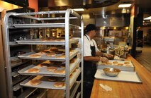 Baker Jessie Torres places cookies on a rack as he gets ready to place them in the baking-oven, Oct. 30 at the David Grant Medical Center dining facility. (U.S. Air Force photo/ Staff Sgt. Liliana Moreno)