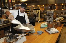 Baker Jessie Torres measures the ingredients for baking a batch of cookies, Oct. 30 at the David Grant Medical Center dining facility. (U.S. Air Force photo/ Staff Sgt. Liliana Moreno)