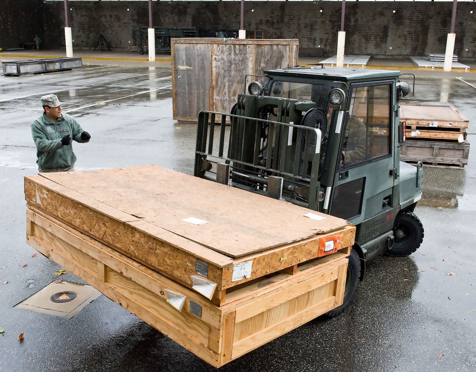 Members of the 436th Logistics Readiness Squadron reposition supply assets from Building 639 to outside covered storage facilities Oct. 30, 2012, at Dover Air Force Base, Del. Assets normally stored outside were brought in prior to Hurricane Sandy?s arrival. (U.S. Air Force photo by Roland Balik)