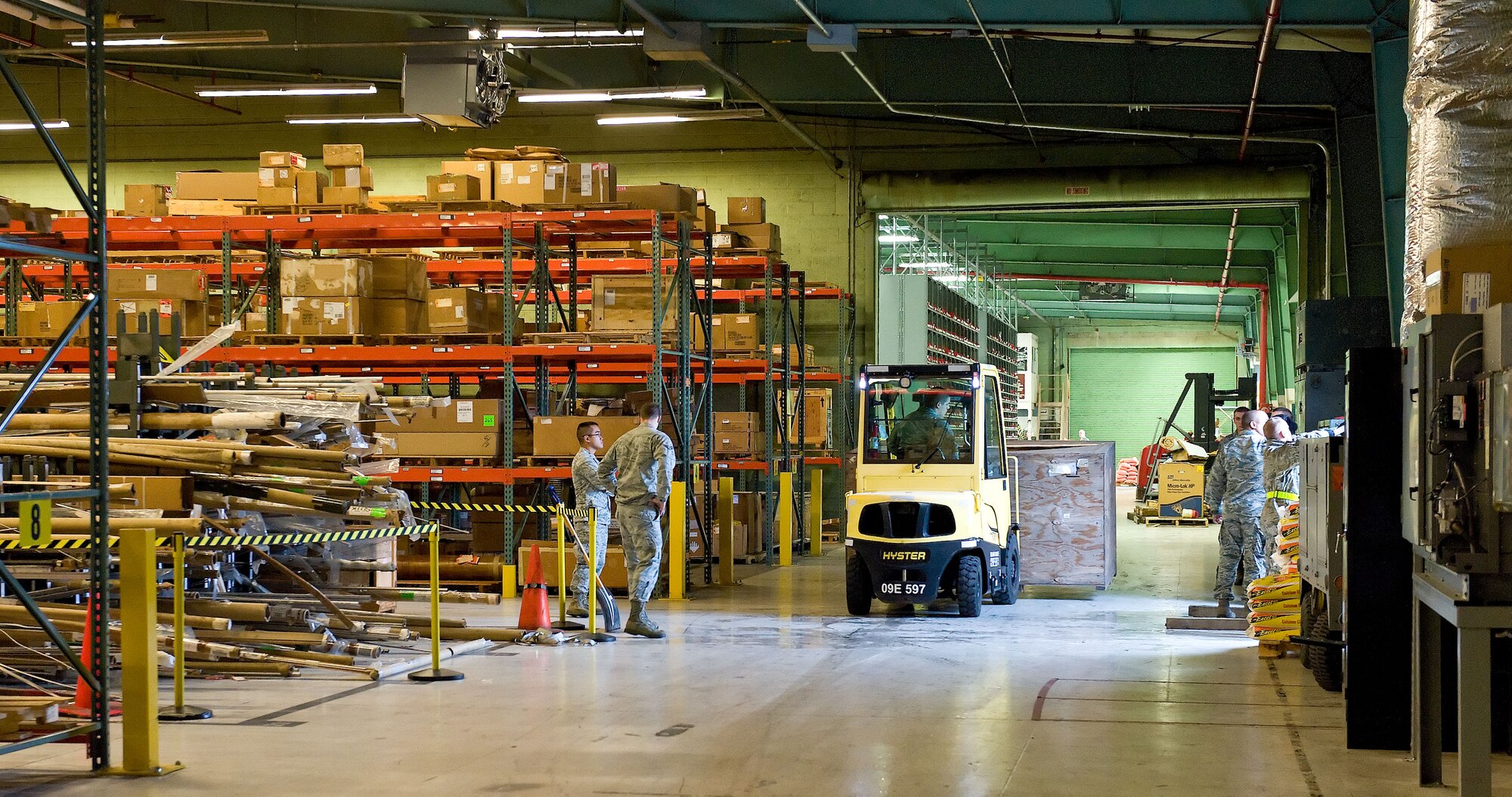 Members of the 436th Logistics Readiness Squadron reposition supply assets in Building 639 Oct. 21, 2012, at Dover Air Force Base, Del. Assets normally stored outside were brought in prior to Hurricane Sandy?s arrival. (U.S. Air Force photo by Roland Balik)