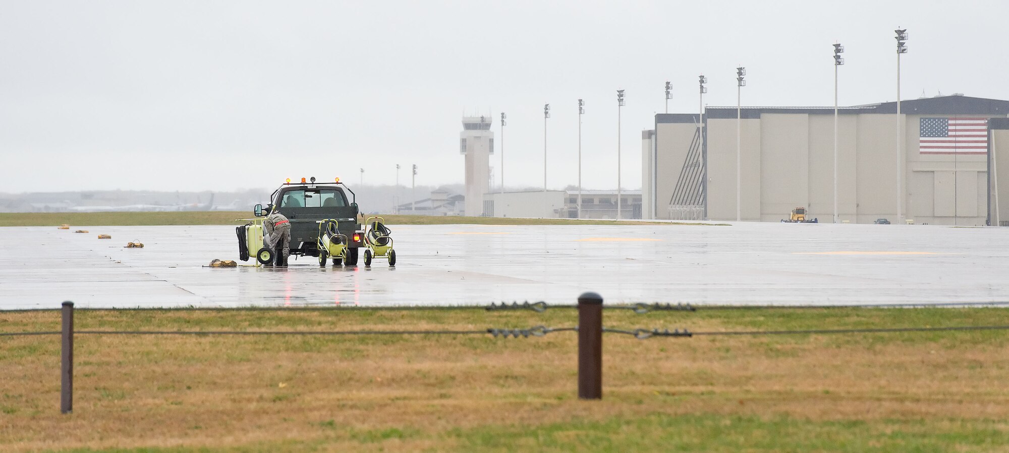 A Team Dover member returns a fire extinguisher to the flight line Oct. 30, 2012, at Dover Air Force Base, Del. Mission essential flight line personnel made preparations for the return of assigned aircraft that were evacuated prior to Hurricane Sandy?s arrival. (U.S. Air Force photo by Roland Balik)