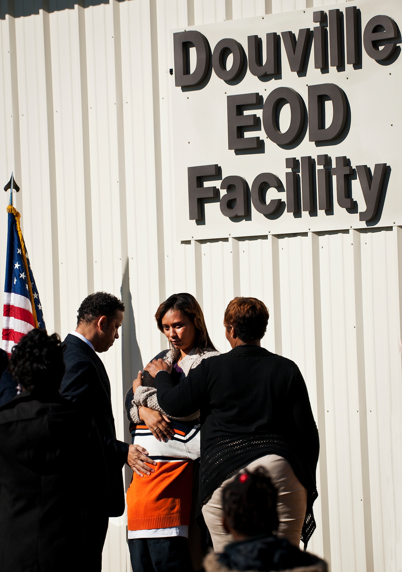 LaShana Douville embraces her son, Daniel Jr., moments after unveiling the sign naming the Eglin Air Force Base explosive ordnance disposal facility after her late husband, Tech. Sgt. Daniel Douville, Oct. 30.  The building was named after Douville, a 96th EOD tech, who died in the line of duty during a deployment to Afghanistan in June 2011.  (U.S. Air Force photo/Samuel King Jr.)