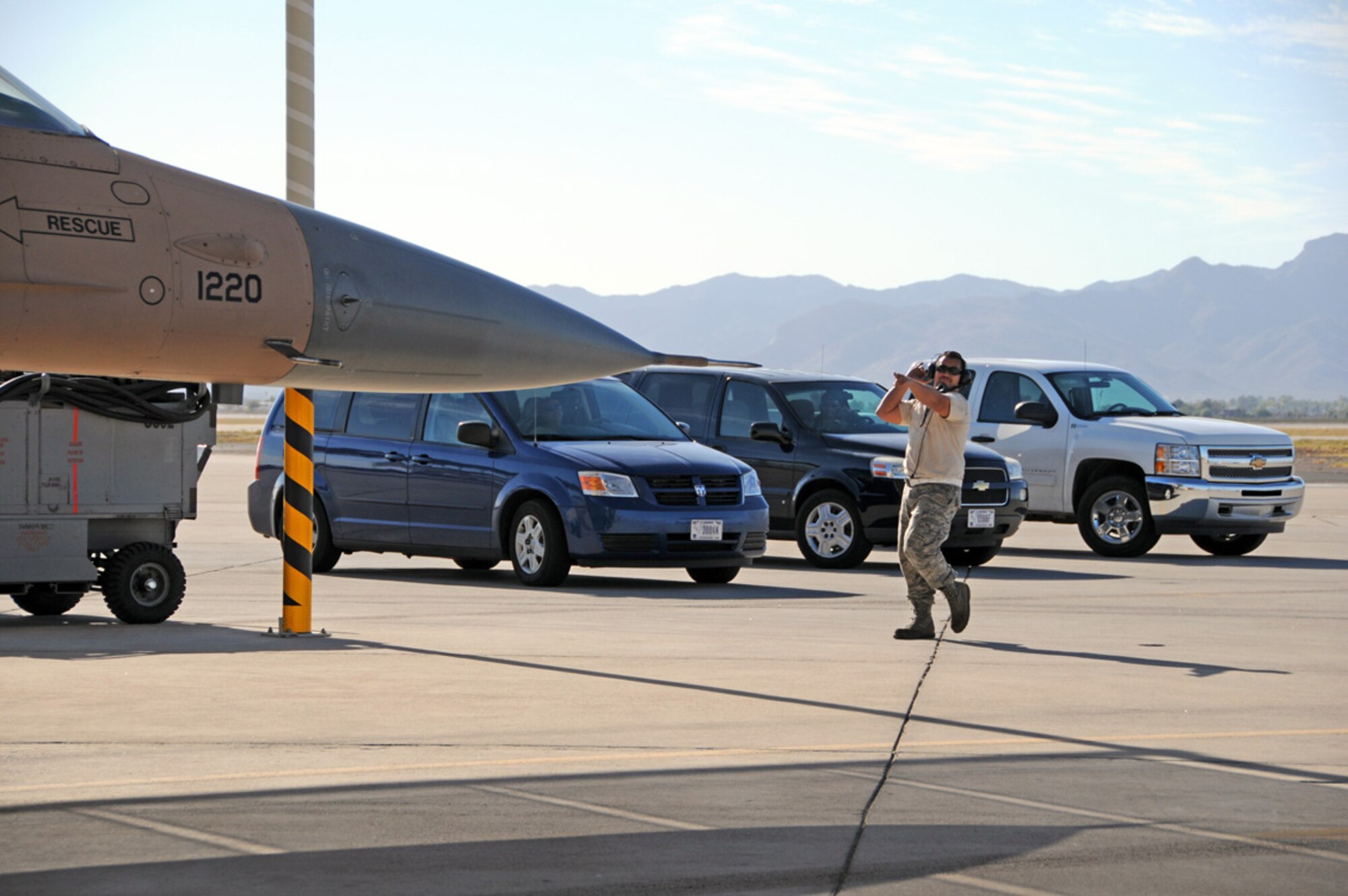 LUKE AIR FORCE BASE, Ariz. -- Staff Sgt. Patrick Ruble, 926th Aircraft Maintenance Squadron crew chief, taxis out an F-16 Aggressor aircraft here Oct. 18. The 926th AMXS is located at Nellis Air Force Base, Nev., and is responsible for maintaining Aggressor aircraft used for Red Flag exercises there. Personnel from the unit traveled to Luke AFB as part of an Aggressor Roadshow in support of a joint training exercise here. (U.S. Air Force photo/Maj. Elizabeth Magnusson)