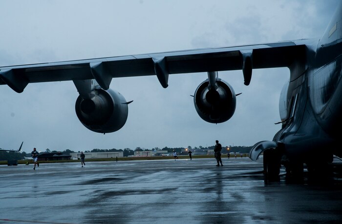 A 628th Security Forces patrolman guards a post on the flight line as participants run the fourth annual Run the Runway 5K event honoring retired Brig. Gen. Thomas Mikolajcik Oct. 27, 2012, at Joint Base Charleston - Air Base, S.C. The 437th Airlift Wing hosted the event which was open to all military, Department of Defense civilians and the local community (U.S. Air Force photo/ Airman 1st Class George Goslin)