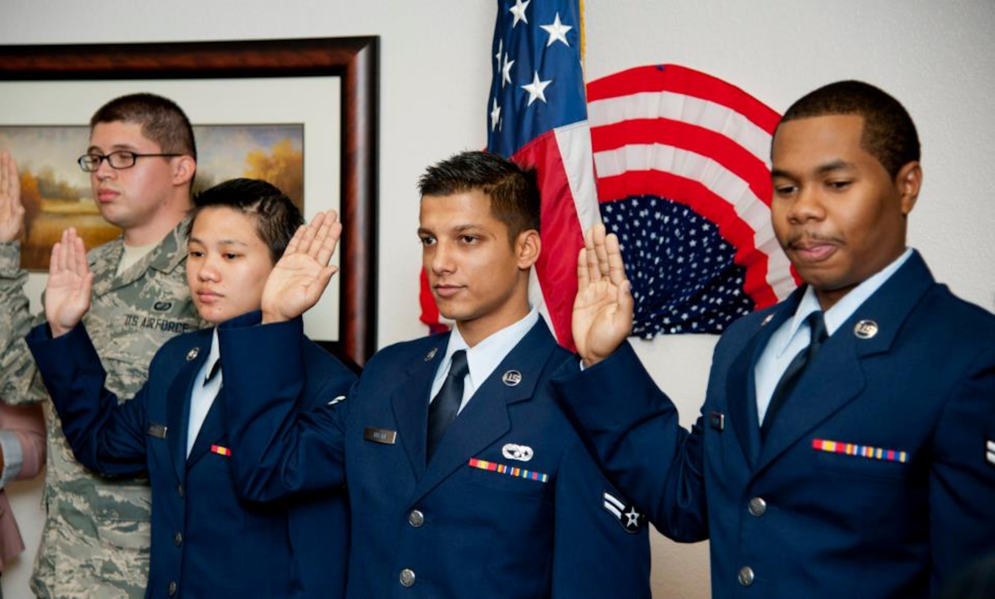 Airman 1st Class Kapil Tiwari, 60th Aerial Port Squadron travel management office second from the right, and three other Airmen take the Oath of Allegiance and becom naturalized citizens Oct. 26. (U.S. Air Force photo/Airman 1st Class Nicole Leidholm)