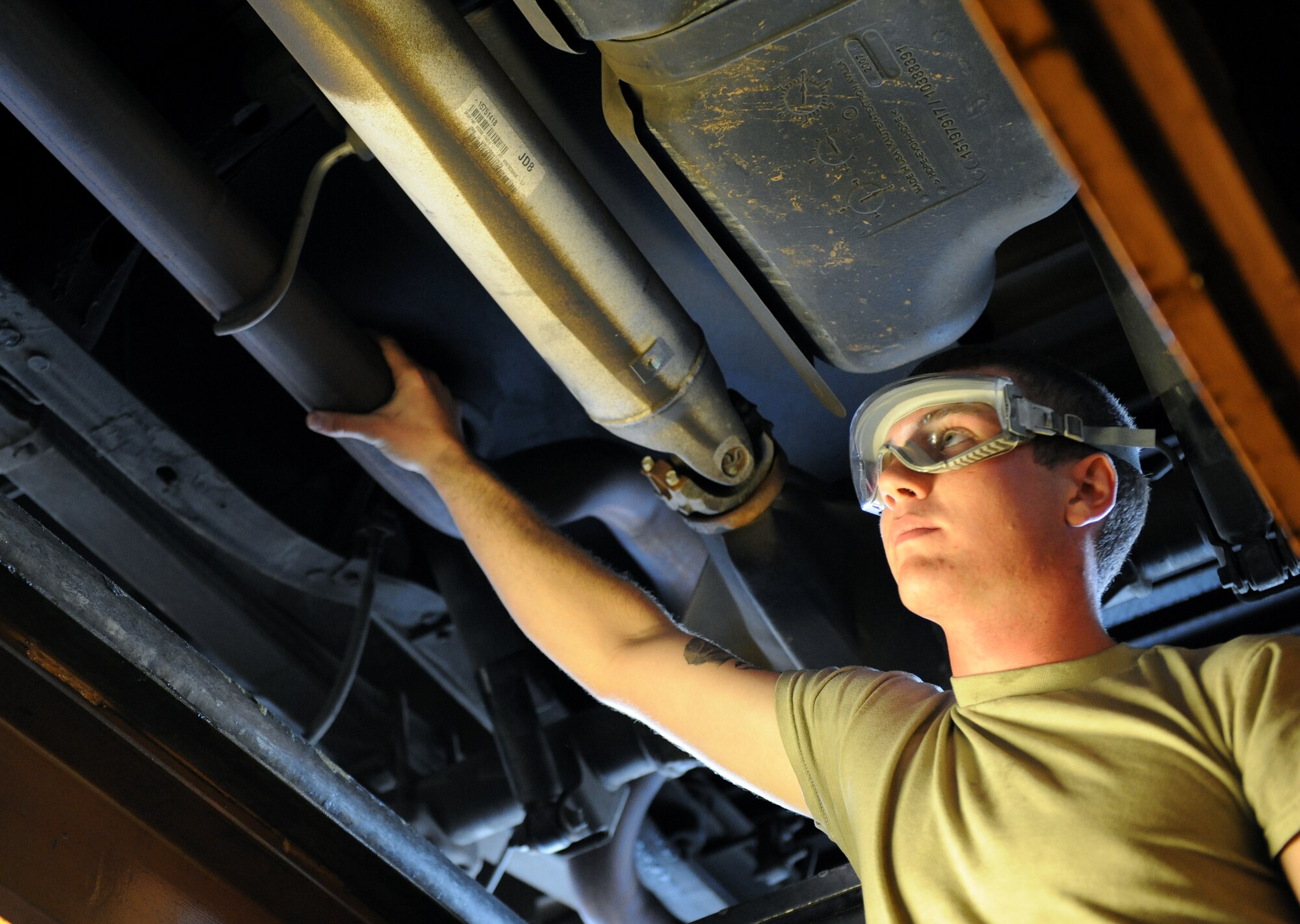 Airman 1st Class Cody Akers, 2nd Logistics Readiness Squadron Vehicle Maintenance lube rack technician, ensures an exhaust pipe is properly connected to a vehicle on Barksdale Air Force Base, La., Oct. 24. Lube rack technicians perform oil changes, filter changes and inspect the vehicles' fluid systems. Every month, more than 50 vehicles are inspected. (U.S. Air Force photo/Airman 1st Class Benjamin Gonsier)(RELEASED)

