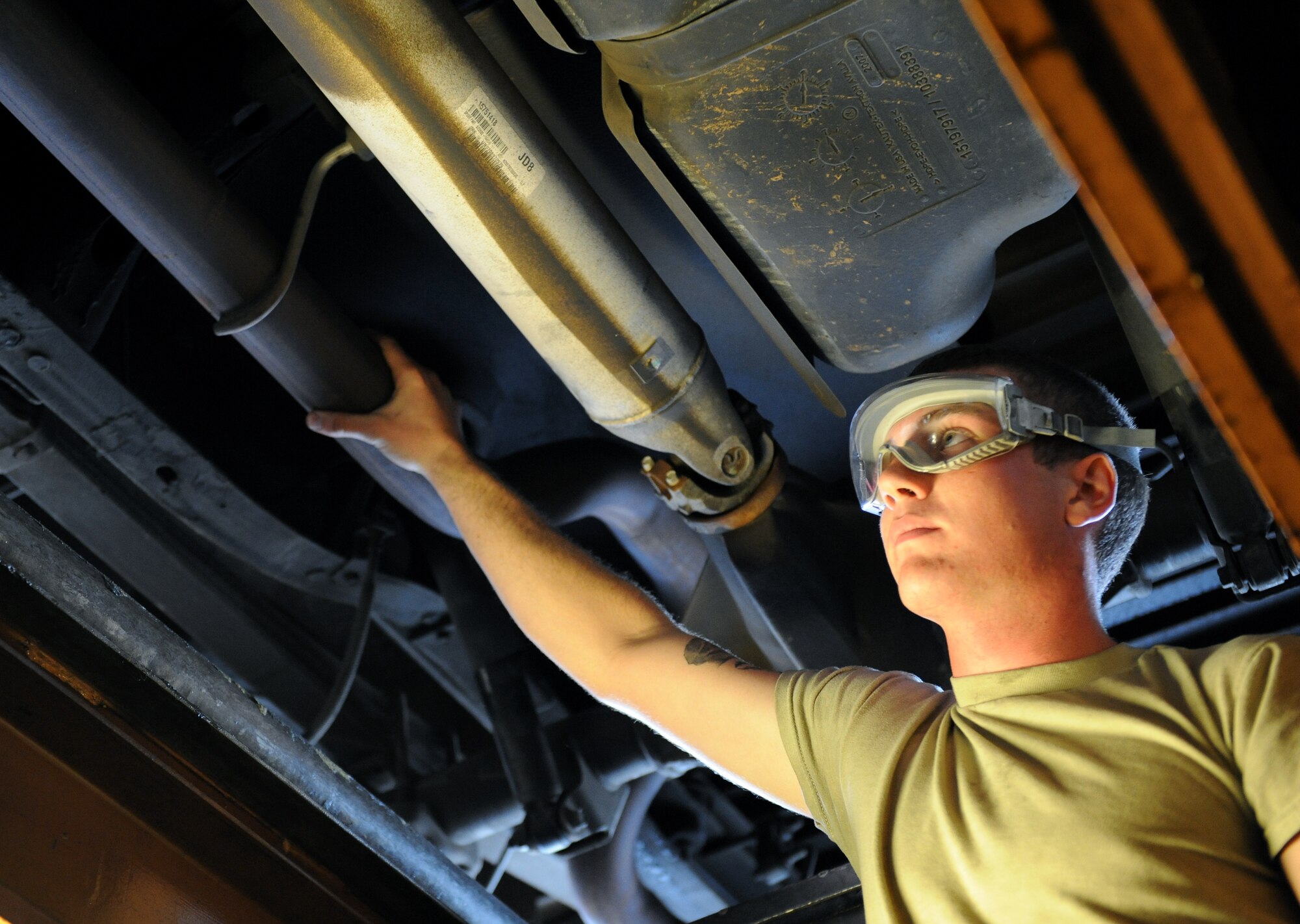Airman 1st Class Cody Akers, 2nd Logistics Readiness Squadron Vehicle Maintenance lube rack technician, ensures an exhaust pipe is properly connected to a vehicle on Barksdale Air Force Base, La., Oct. 24. Lube rack technicians perform oil changes, filter changes and inspect the vehicles' fluid systems. Every month, more than 50 vehicles are inspected. (U.S. Air Force photo/Airman 1st Class Benjamin Gonsier)(RELEASED)

