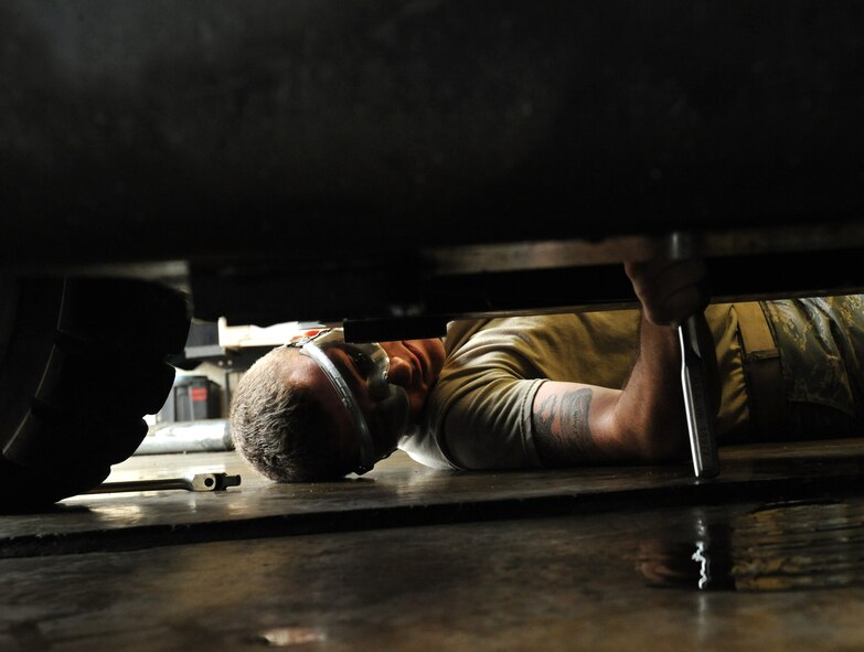 Airman 1st Class Cody Akers, 2nd Logistics Readiness Squadron Vehicle Maintenance lube rack technician, tightens an oil drain plug underneath a vehicle on Barksdale Air Force Base, La., Oct. 24. Lube rack technicians perform oil changes, filter changes and inspect the vehicles' fluid systems. (U.S. Air Force photo/Airman 1st Class Benjamin Gonsier)(RELEASED)

