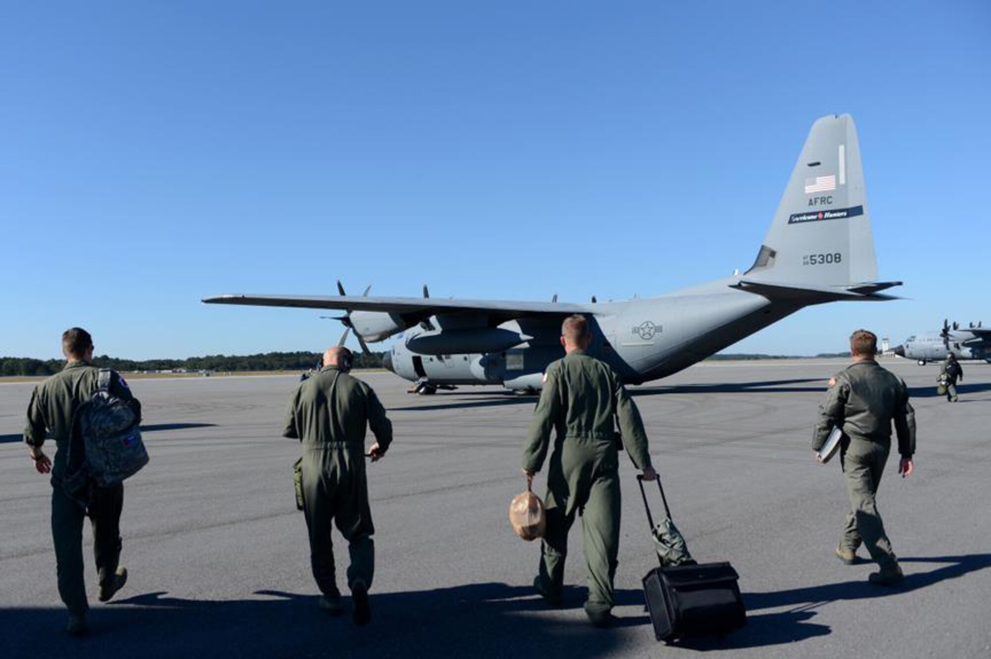 A WC-130J Hercules crew from the 53rd Weather Reconnaissance Squadron walk to their aircraft for a weather reconnaissance mission into Hurricane Sandy Oct. 29, 2012, at Hunter Army Airfield, Ga. The 53rd WRS conducted weather reconnaissance missions in preparation for Hurricane Sandy making landfall along the Eastern coastline of the United States. (U.S. Air Force photo/Staff Sgt. Jason Robertson)
