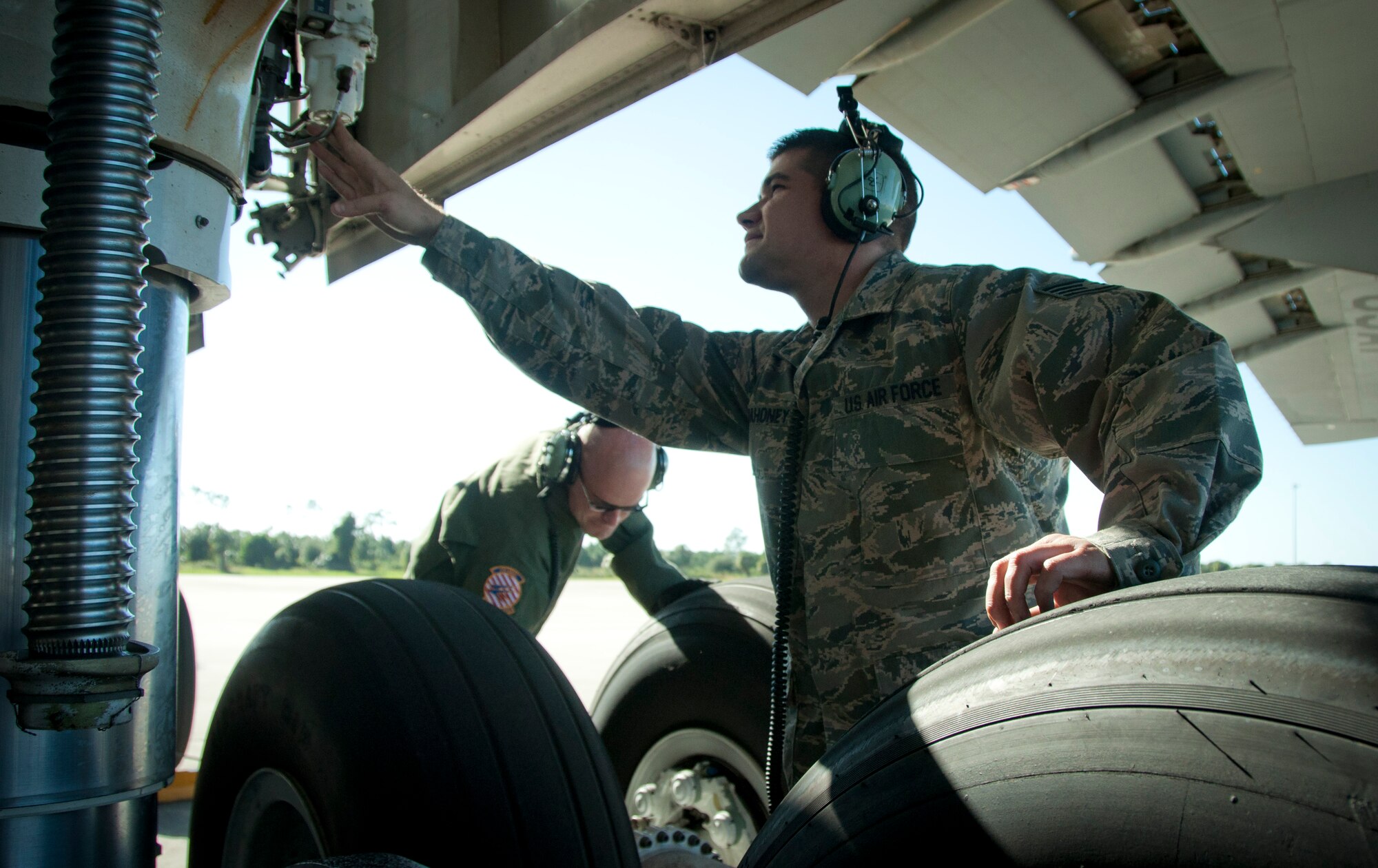 MACDILL AIR FORCE BASE, Fla. – After a long flight in their C-5B Galaxy, Staff Sgt. Joe Mahoney, left, a hydraulic technician with the 439th Aircraft Maintenance Squadron, and Tech. Sgt. Devon Dostefano, right, an electrician with the same squadron, perform post–flight checks on the wheels of the aircraft.  The 439th Air Wing, located in Westover, Mass., evacuated 16 of the airplanes to MacDill in anticipation of Hurricane Sandy's landfall yesterday.  The planes are some of the largest in the world and are collectively valued at over 3 billion dollars.  (Official U.S. Air Force photo/Staff Sgt. Shawn Rhodes)
