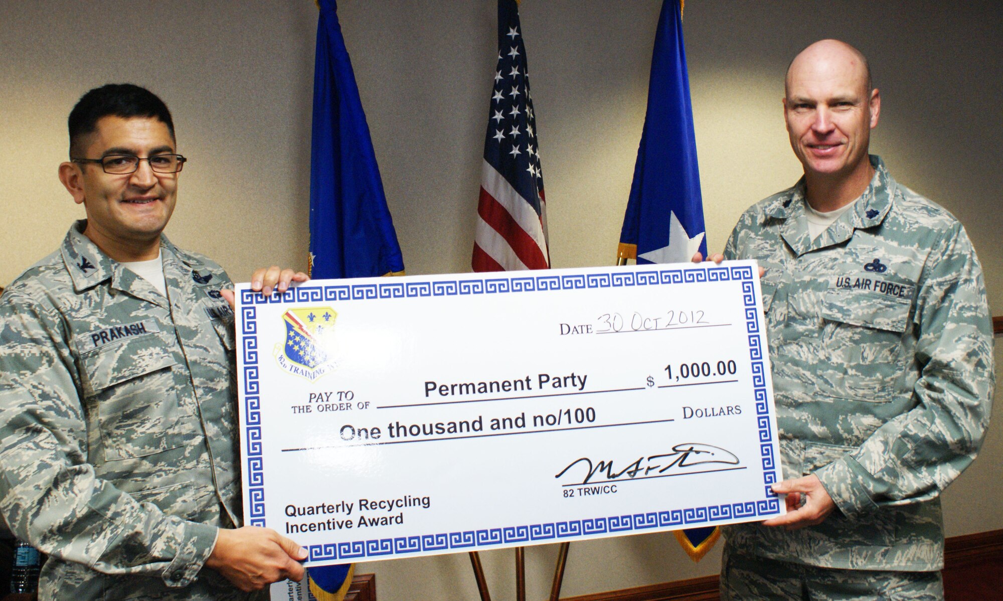 Col. Om Prakash (left), 82nd Training Wing vice-commander, congratulates Lt. Col. Jeffrey Sloan, 982nd Training Group vice-commander, for being named the 4th quarter 2012 Sheppard Air Force Base Recycling Incentive Award winner in the permanent party category.  The winners receive a $1,000 award to be used for quality of life projects. (U.S. Air Force photo/Dan Hawkins)