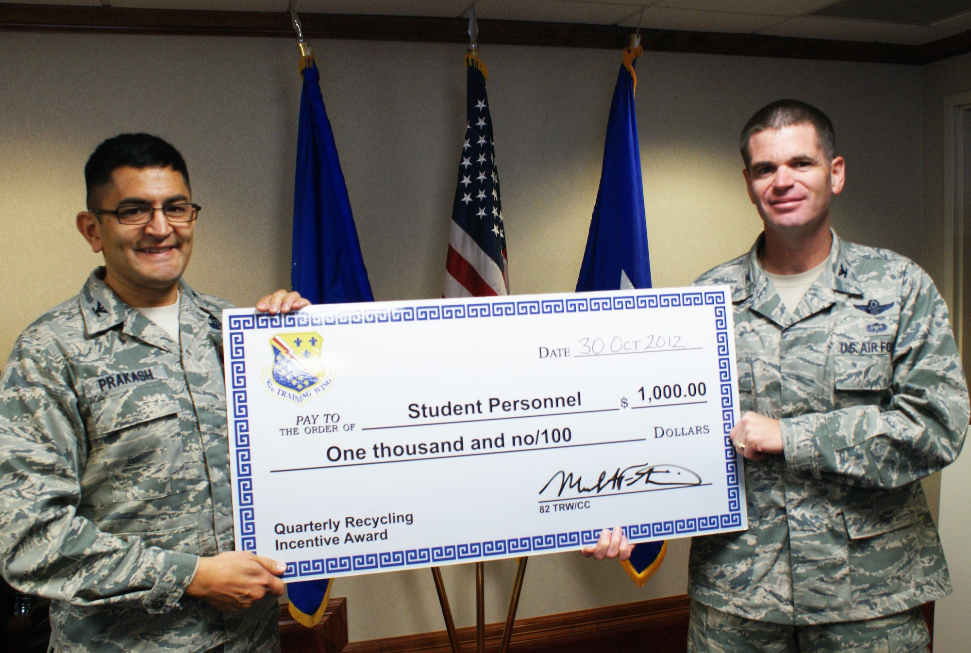 Col. Om Prakash (left), 82nd Training Wing vice-commander, congratulates Col. David Murphy, 782nd Training Group commander, for being named the 4th quarter 2012 Sheppard Air Force Base Recycling Incentive Award winner in the student category.  The winners receive a $1,000 award to be used for quality of life projects. (U.S. Air Force photo/Dan Hawkins)