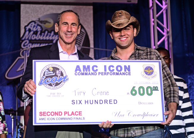 Staff Sgt. Tiry Crane, accepts his second place award after performing for a crowd of more than 200 at the Scott Air Force Base club Oct. 25, 2012. Ten performers participated in the 2012 AMC Icon, a contest similar to the famed American Idol in which contestants competed for cash prizes and a spot to perform in the U.S. Air Force Tops in Blue group. 1Lt. Nicole White took the top prize with Staff Sgt. Tiry Crane as the runner up and TSgt Doug Boren in third place. (U.S. Air Force photo/ Staff Sgt. Ryan Crane)