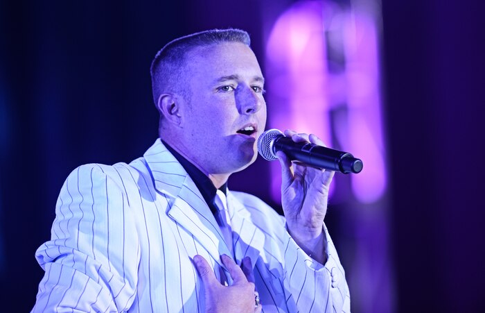 Tech. Sgt. Doug Boren, from McConnell Air Force Base, performs for the judges and a crowd of more than 200 at the Scott Air Force Base club Oct. 25, 2012. Ten performers participated in the 2012 AMC Icon, a contest similar to the famed American Idol in which contestants competed for cash prizes and a spot to perform in the U.S. Air Force Tops in Blue group. 1Lt Nicole White took the top prize with Staff Sgt. Tiry Crane as the runner up and TSgt Doug Boren in third place. (U.S. Air Force photo/ Staff Sgt. Ryan Crane)