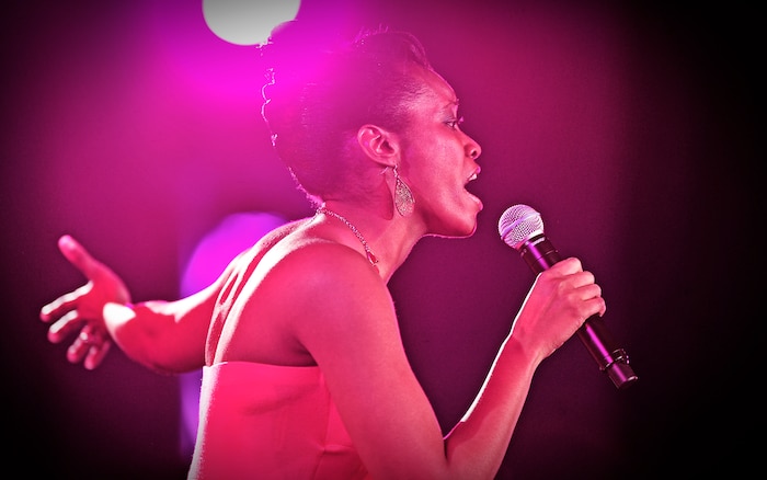 1Lt. Nicole White, Air Mobility Command public affairs, performs for the judges and a crowd of more than 200 at the Scott Air Force Base club Oct. 25, 2012. Ten performers participated in the 2012 AMC Icon, a contest similar to the famed American Idol in which contestants competed for cash prizes and a spot to perform in the U.S. Air Force Tops in Blue group. 1Lt Nicole White took the top prize with Staff Sgt. Tiry Crane as the runner up and TSgt Doug Boren in third place. (U.S. Air Force photo/ Staff Sgt. Ryan Crane)