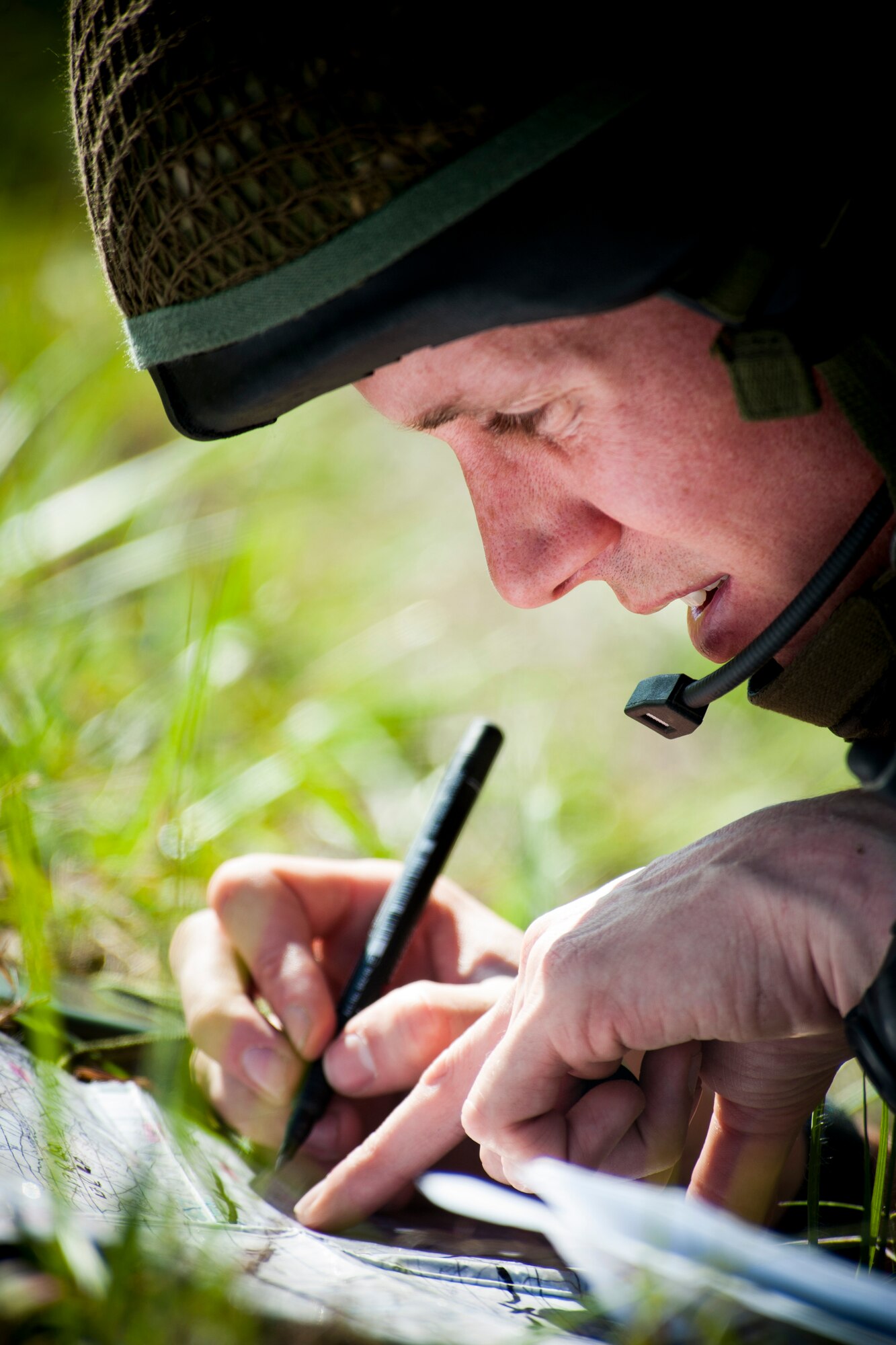 British army Flight Lieutenant Steve Burr, 7th Armored Brigade joint terminal attack controller, writes down target information during Exercise Flying Rhino in South Georgia, Oct. 23, 2012. Keeping track of data such as landmark and enemy positions helps JTACS and pilots stay on the same page while directing and performing air strikes. (U.S. Air Force photo by Staff Sgt. Jamal D. Sutter/Released)