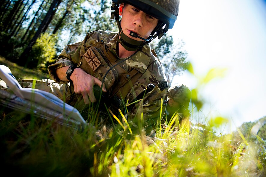 British army Flight Lieutenant Steve Burr, 7th Armored Brigade joint terminal attack controller, communicates with an A-10C Thunderbolt II pilot during Exercise Flying Rhino in South Georgia, Oct. 23, 2012. With A-10s being a commonly used close-air support aircraft during deployments, JTACs around the world regularly train with them to stay proficient at what they do. (U.S. Air Force photo by Staff Sgt. Jamal D. Sutter/Released) 