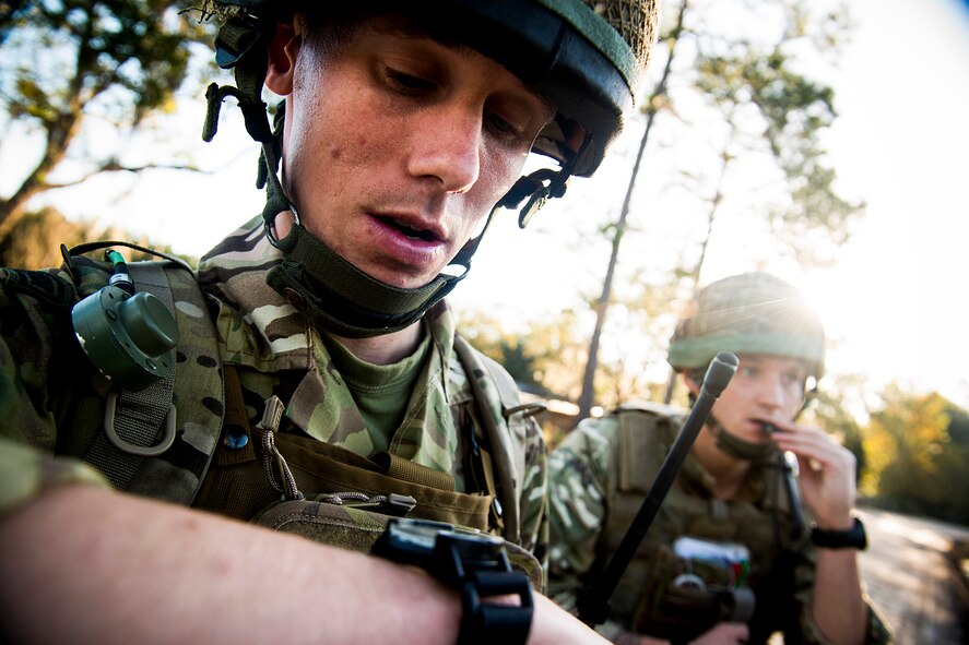 British army Flight Lieutenant Steve Burr checks his compass as Sgt. Christopher Smith communicates with an A-10C Thunderbolt II pilot during Exercise Flying Rhino in South Georgia, Oct. 23, 2012. Both are 7th Armored Brigade joint terminal attack controllers who visited Moody Air Force Base, Ga., to conduct close-air support familiarization with pilots from the 74th and 75th Fighter Squadrons. (U.S. Air Force photo by Staff Sgt. Jamal D. Sutter/Released)    