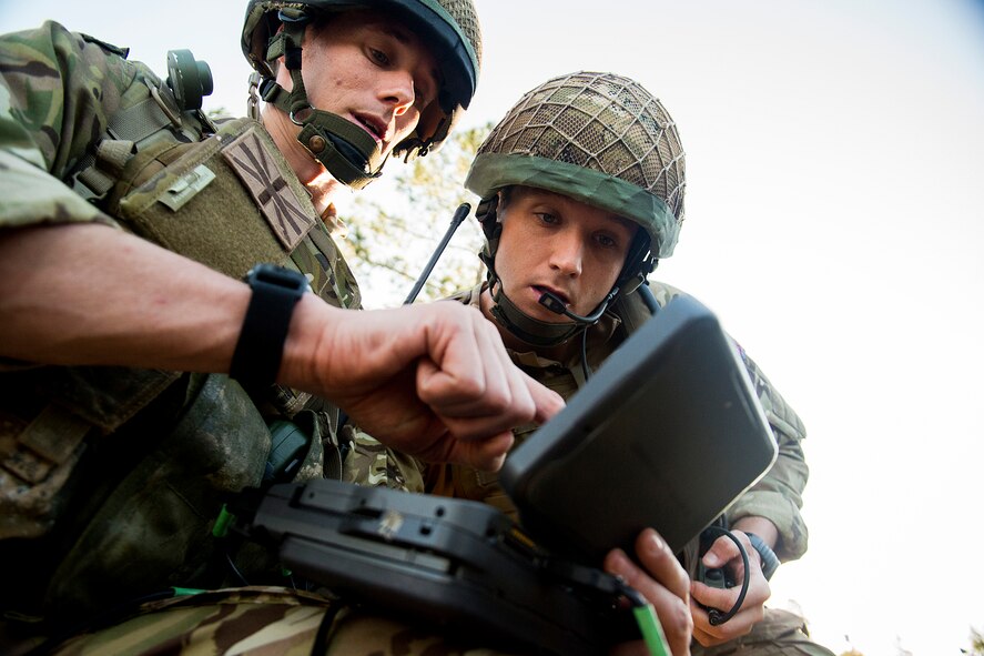 British army Flight Lieutenant Steve Burr checks and Sgt. Christopher Smith, both joint terminal attack controllers with the 7th Armored Brigade out of Germany, review information on a video downlink receiver during Exercise Flying Rhino in South Georgia, Oct. 23, 2012. The JTACs combined their training requirements with those of 74th and 75th Fighter Squadron pilots to simulate missions faced while deployed. (U.S. Air Force photo by Staff Sgt. Jamal D. Sutter/Released)  