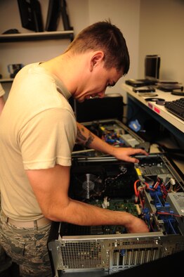 WHITEMAN AIR FORCE BASE, Mo. -- Senior Airman Wesley Snider, 509th CS client services technician, disconnects cables of a desktop computer’s communications and networking system Sept. 6. Workers in the focal point are selected for their ability to think through various communications issues and respond appropriately and professionally. (U.S. Air Force photo/Senior Airman Nick Wilson) (Released)