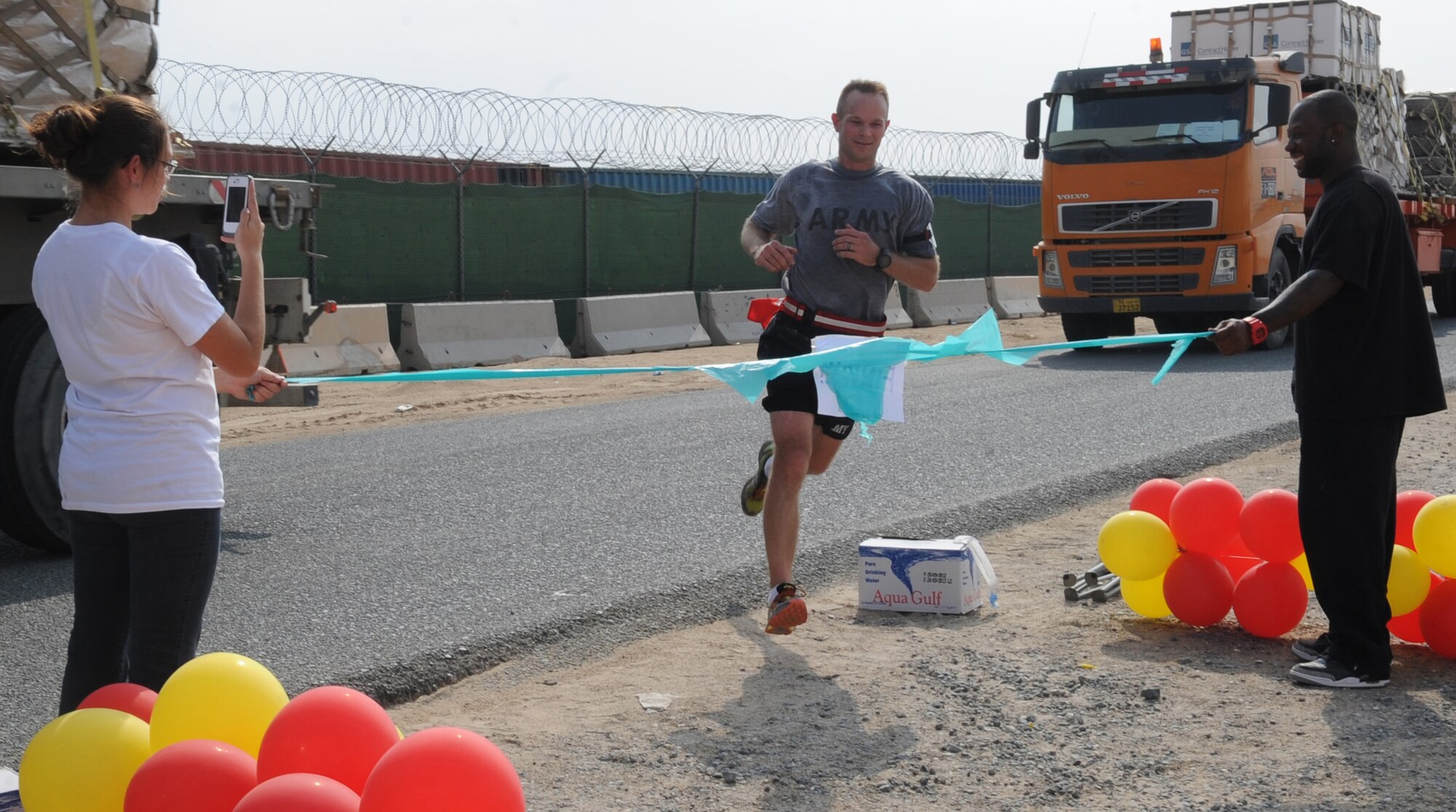 SOUTHWEST ASIA – U.S. Army Sgt. 1st Class Jonathon Orloski, 544th Engineering Company, crosses the finish line of the U.S. Marine Corps Marathon Forward here Oct. 28. He finished his first marathon in three hours, 24 minutes and 42 seconds, placing him in first overall. (U.S. Air Force photo/Staff Sgt. Alexandra M. Boutte)