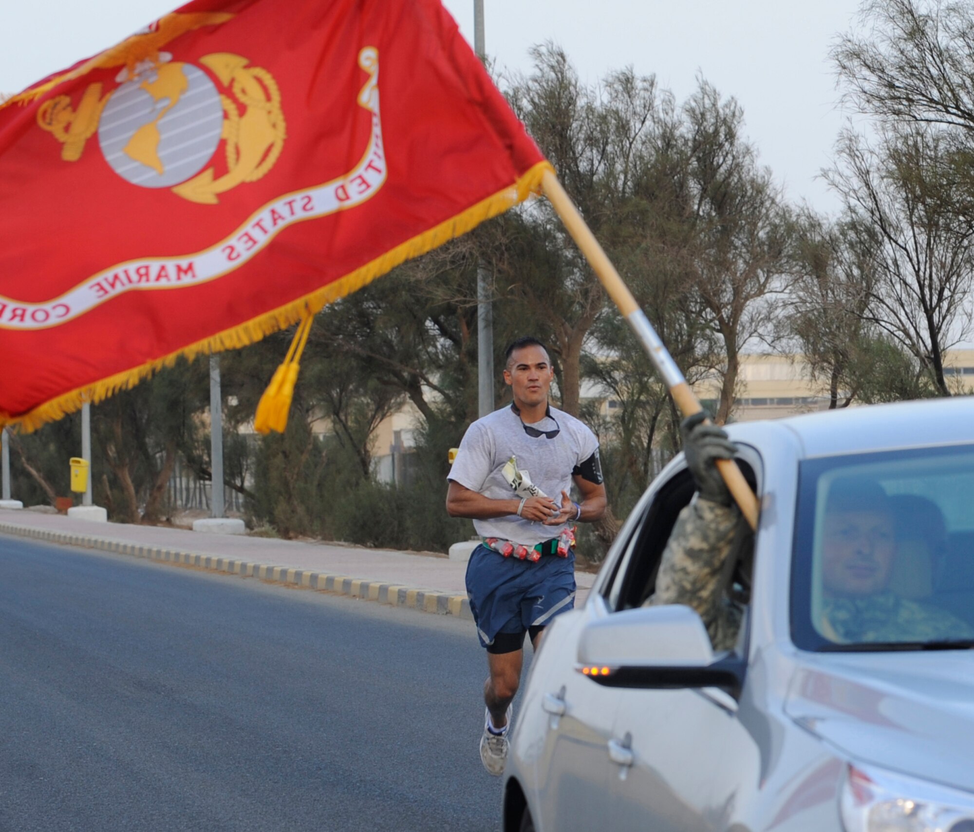 SOUTHWEST ASIA – Air Force Tech. Sgt. Damien Usita, 386th Expeditionary Operation Support Squadron weather flight non-commissioned officer-in-charge, runs behind the pace-car for the first two laps of the U.S. Marine Corps Marathon Forward here Oct. 28. Usita took an overall of third place in his first marathon with a time of three hours and 44 minutes. (U.S. Air Force photo/Staff Sgt. Alexandra M. Boutte)