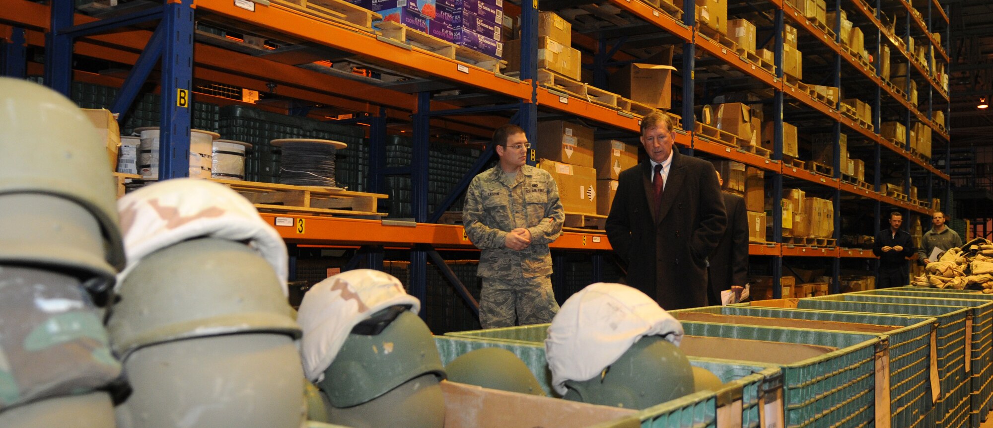 Senior Airman Steven Lauzon, 100th Logistics Readiness Squadron Individual Protective Equipment technician, shows Terry Yonkers, Assistant Secretary of Air Force Installations, Environments and Logistics, around the 100th LRS IPE Element Oct. 29, 2012, during a visit to RAF Mildenhall, England. The assistant secretary thanked Airmen for their service and spent a few moments learning about their families, hobbies and how they feel about being stationed in the United Kingdom. Yonkers also visited RAF Lakenheath and is scheduled to visit RAF Alconbury. (U.S. Air Force photo by Staff Sgt. Austin M. May/Released)
