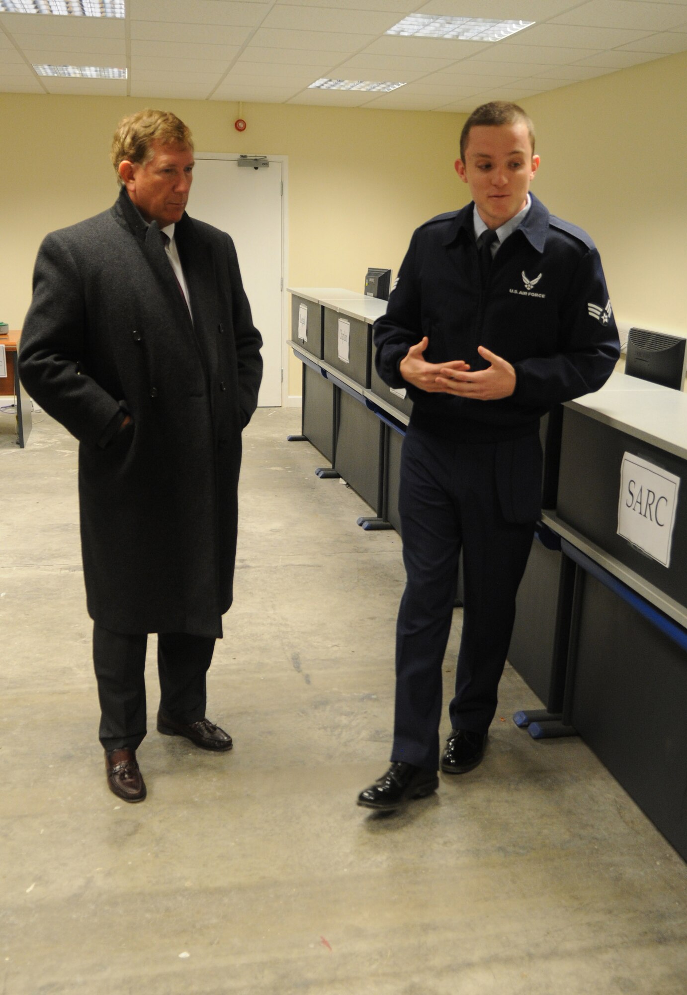 Senior Airman Sean Leming, 100th Logistics Readiness Squadron deployments apprentice, shows Terry Yonkers, Assistant Secretary of Air Force Installations, Environments and Logistics, around the 100th LRS Deployment Processing Facility Oct. 29, 2012, during a visit to RAF Mildenhall, England. The assistant secretary thanked Airmen for their service and spent a few moments learning about their families, hobbies and how they feel about being stationed in the United Kingdom. Yonkers also visited RAF Lakenheath and is scheduled to visit RAF Alconbury. (U.S. Air Force photo by Staff Sgt. Austin M. May/Released)
