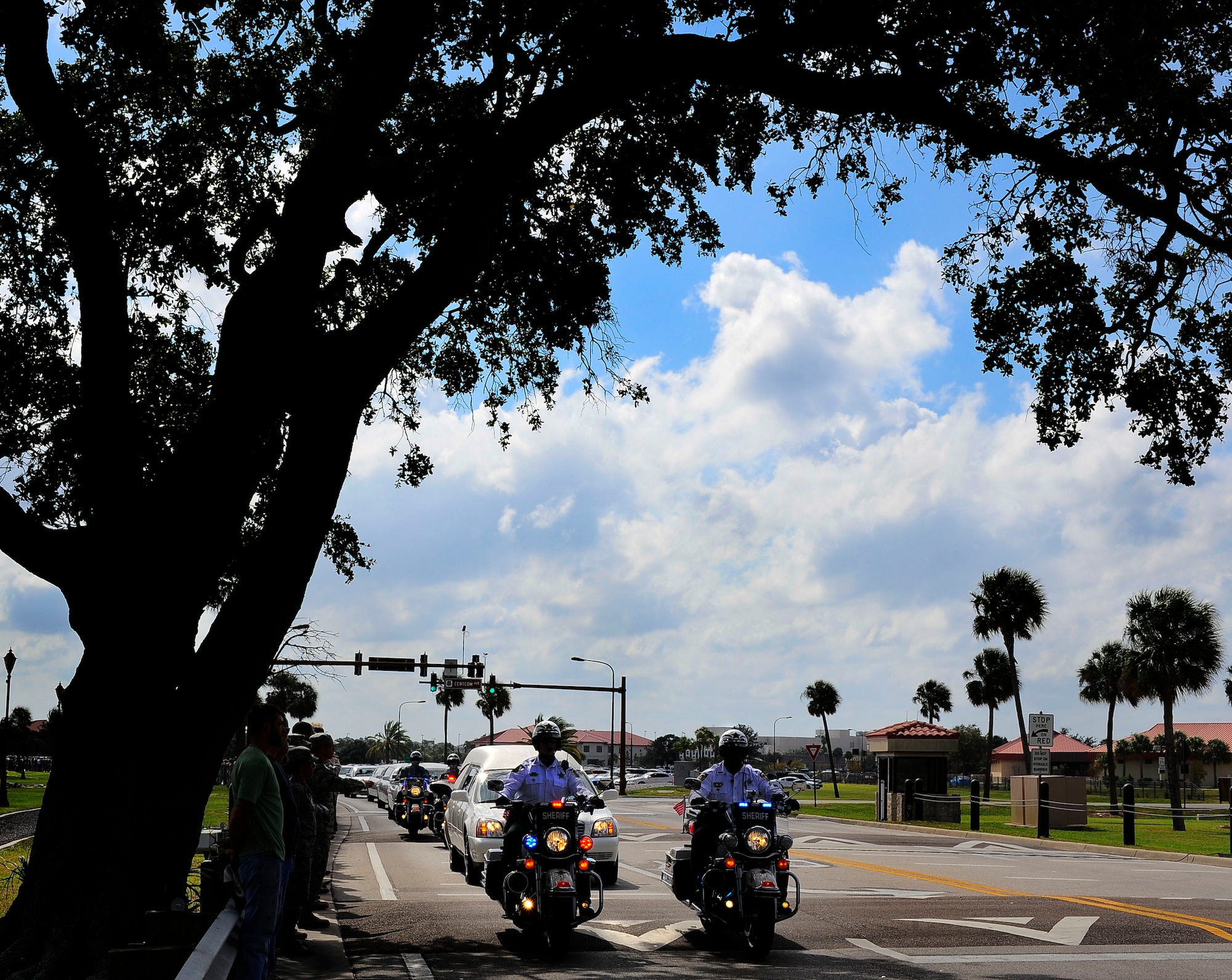 Hillsborough County Sheriff's department motorcade escort Spc. Brittany B. Gordon’s procession off of MacDill Air Force Base, Fla., while service member and civilians pay their respects by lining the streets Oct 24, 2012. Gordon died of wounds suffered when enemy forces attacked her unit with an improvised explosive device while supporting Operation Enduring Freedom in Kandahar, Afghanistan. Gordon was assigned to the 572nd Military Intelligence Company, 2nd Stryker Brigade Combat Team, 2nd Infantry Division at Joint Base Lewis-McChord, Wash. (U.S. Air Force photo by Staff Sgt. Angela Ruiz/Released)