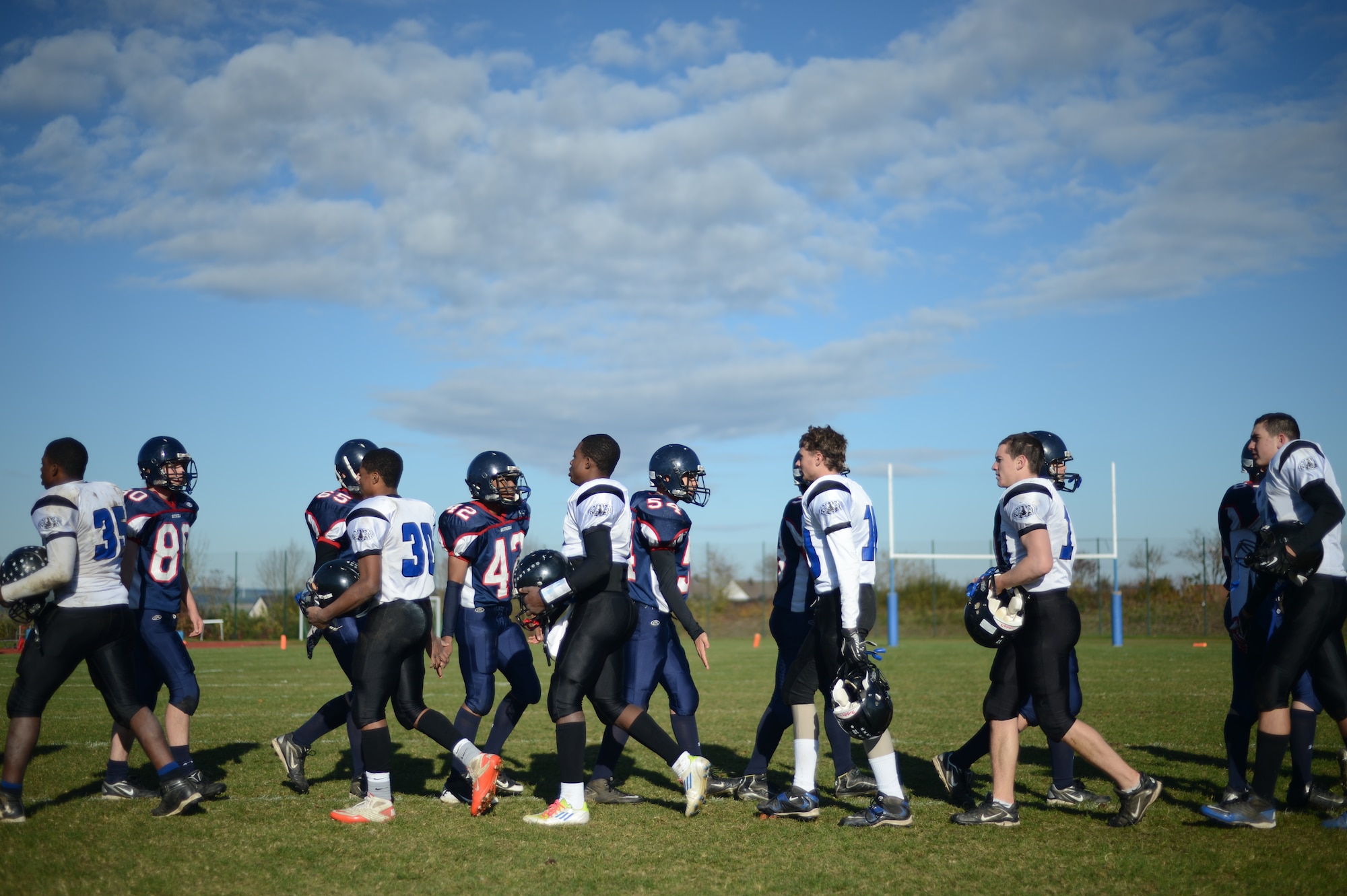 BITBURG ANNEX, Germany – Players from the Bitburg Barons and Hohenfels Tigers congratulate each other after their game at Rik Carr Field Oct. 27, 2012. The Barons defeated the Tigers 56 – 14 in their final home game of the season and clinched a spot in the Department of Defense Dependents Schools Europe Division-II championship for the fourth consecutive year. (U.S. Air Force photo by Staff Sgt. Nathanael Callon/Released)