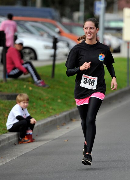 Senior Airman Sarah Vrachalus, 35th Logistics Readiness Squadron inbound cargo, finishes her final stretch of the Breast Cancer Run 2012 at Misawa Air Base, Japan, Oct. 27, 2012. Vrachalus, like many others, ran the base perimeter at the event while others chose to run in a 5K or 10K. (U.S. Air Force photo by Airman 1st Class Zachary Kee)