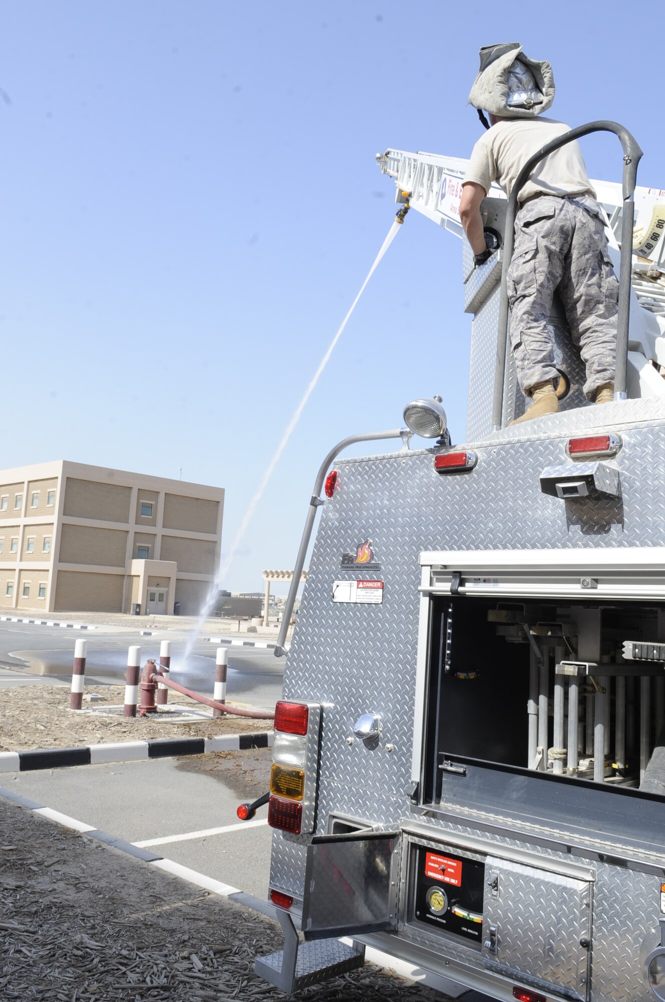 SOUTHWEST ASIA – Staff Sgt. Christopher Wood, 386th Expeditionary Civil Engineer Squadron firefighter crew chief, operates the ladder to run water from an aerial position here Sept. 28. Members of the fire department took a practical exam for driver/operator aerial devices. Ladder training can take from a few weeks to a few months. (U.S. Air Force photo/Staff Sgt. Alexandra M. Boutte)