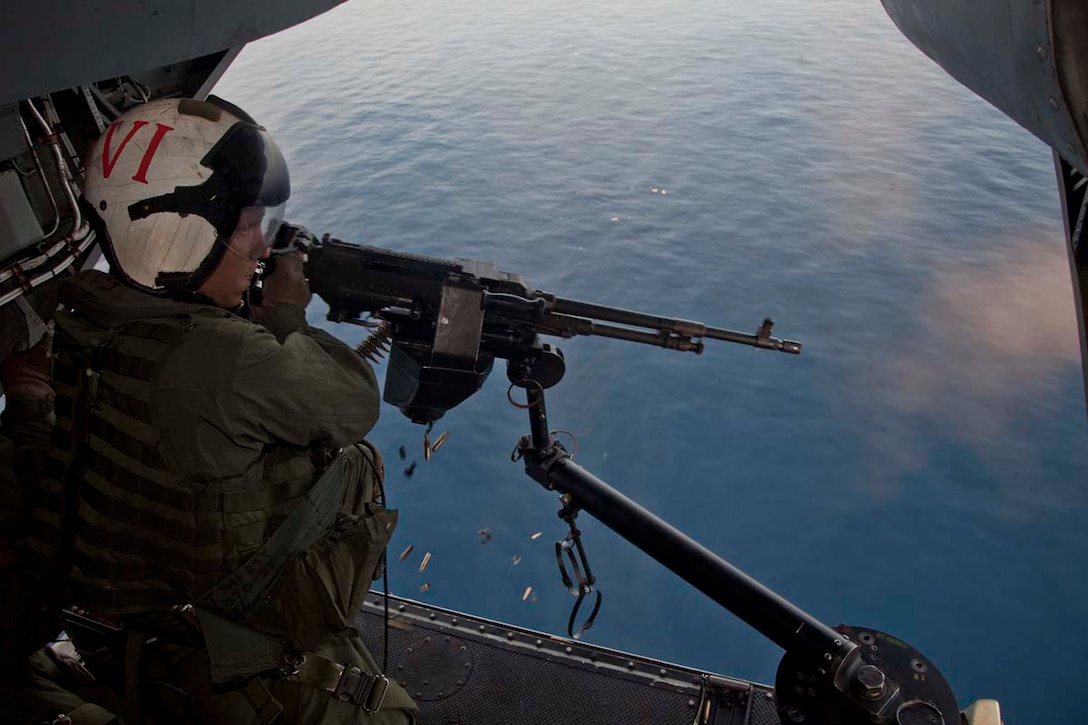 Sergeant John H. Kirk VI, aerial gunner and observer and a CH-46E Sea Knight mechanic, Marine Medium Helicopter Squadron 364 (Rein.), 15th Marine Expeditionary Unit, fires a M240D machine gun while flying over the Indian Ocean, Oct. 25. Marine Medium Helicopter Squadron 364 (Rein.), 15th Marine Expeditionary Unit conducted aerial gunnery and tail gunnery training to refresh the skills of eight of the unit’s crew chiefs as well as aerial tail gunnery qualifications for two of their aerial observers. The 15th MEU is comprised of approximately 2,400 Marines and sailors and is currently embarked as part of the Peleliu Amphibious Ready Group, while they serve as the nation's rapid-response sea-based Marine Air Ground Task Force for Western Pacific Deployment 12-02. Kirk, 25, is from Ramona, Calif.