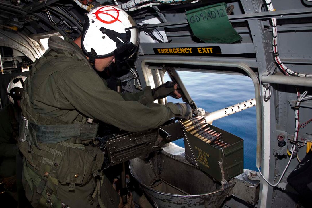 Corporal Heriberto Velazquez II, CH-46E aerial observer and mechanic, Marine Medium Helicopter Squadron 364 (Rein.), 15th Marine Expeditionary Unit, loads .50 caliber rounds into a XM-218 machine gun while flying over the Indian Ocean, Oct. 25. Marine Medium Helicopter Squadron 364 (Rein.), 15th Marine Expeditionary Unit conducted aerial gunnery and tail gunnery training to refresh the skills of eight of the unit’s crew chiefs as well as aerial tail gunnery qualifications for two of their aerial observers. The 15th MEU is comprised of approximately 2,400 Marines and sailors and is currently embarked as part of the Peleliu Amphibious Ready Group, while they serve as the nation's rapid-response sea-based Marine Air Ground Task Force for Western Pacific Deployment 12-02. Velazquez, 22, is from Newport News, Va.