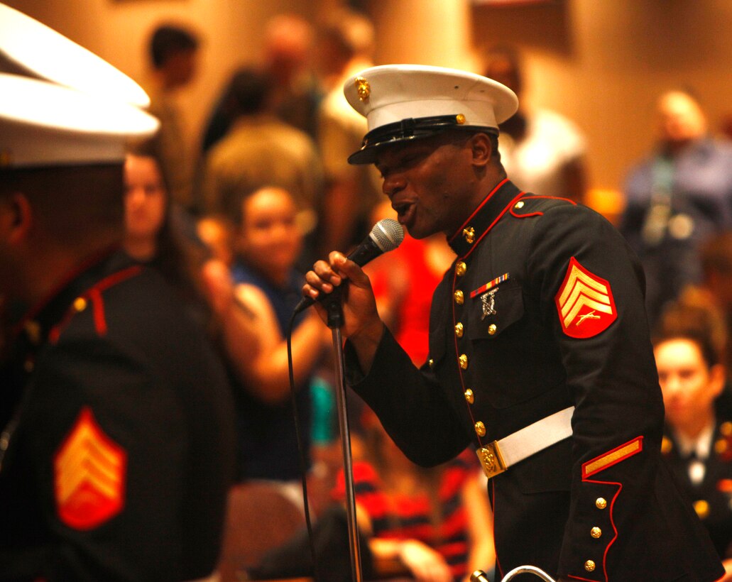 Sgt. Michael Joseph, a trumpeter from the Marine Corps Band New Orleans, pumps up the crowd during a performance at William Floyd High School in Mastic Beach, N.Y., Oct. 25, 2012.  Joseph is a New Orleans native and has served more than four years in the Marine Corps.  (U.S. Marine Corps Photo by Cpl. Nana Dannsa-Appiah/Released)