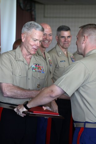 The Commandant of the Marine Corps, General James F. Amos, and the Sergeant Major of the Marine Corps, Sgt. Major Michael P. Barret, give the Superior Achiever Award to Marines aboard Naval Air Station North Island, Coronado, Oct. 26. The award is earned by meeting or exceeding specified recruiting goals. Marines from recruitng sections acro0ss the country journeyed to to the naval base to be presented the award.