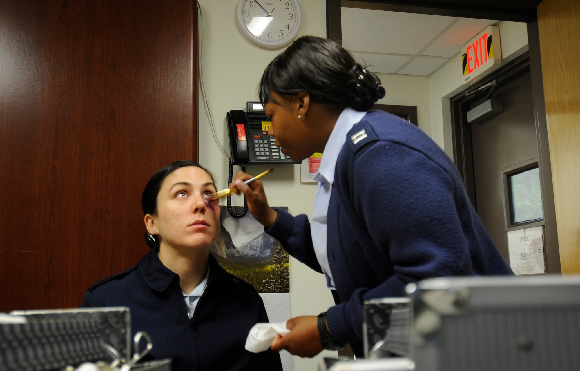 Senior Airman Jessica Hines, 8th Fighter Wing Public Affairs, has a black eye painted onto her face by Capt. Sharise Bijou, Family Advocacy officer, at Kunsan Air Base, Republic of Korea, Oct. 22, 2012. The Black Eye Campaign was hosted by the Family Advocacy Clinic in observance of Domestic Violence Awareness Month. (U.S. Air Force photo/Staff Sgt. Kristopher Kingan)