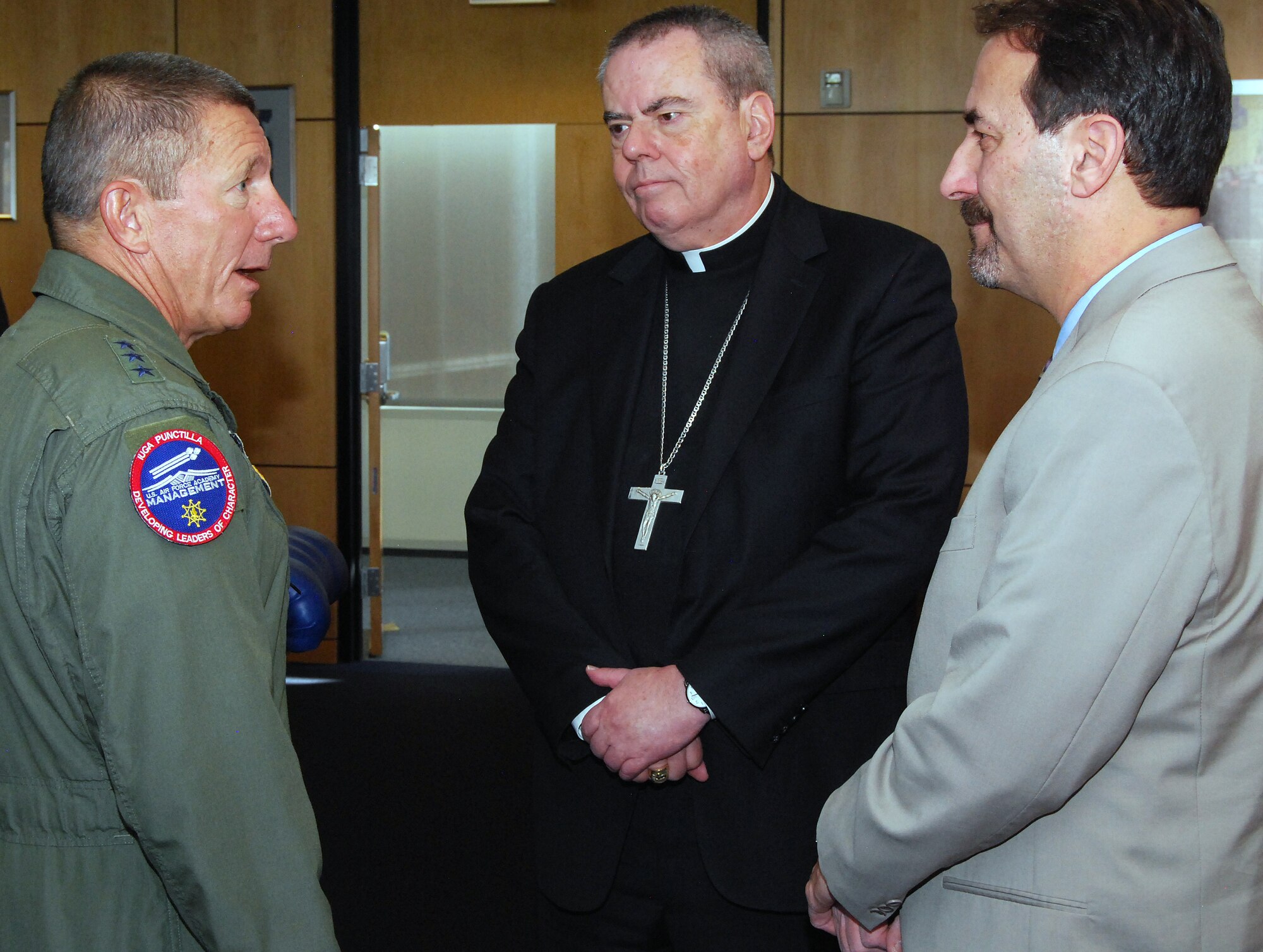 Air Force Academy Superintendent Lt. Gen. Mike Gould speaks with Bishop Michael Sheridan and Scott Levin during the Academy's 2012 religious respect conference. Sheridan represents the Catholic Archdiocese for the Military Services. Levin is director of the Rocky Mountain Region of the Anti-Defamation League. (U.S. Air Force photo/Don Branum)