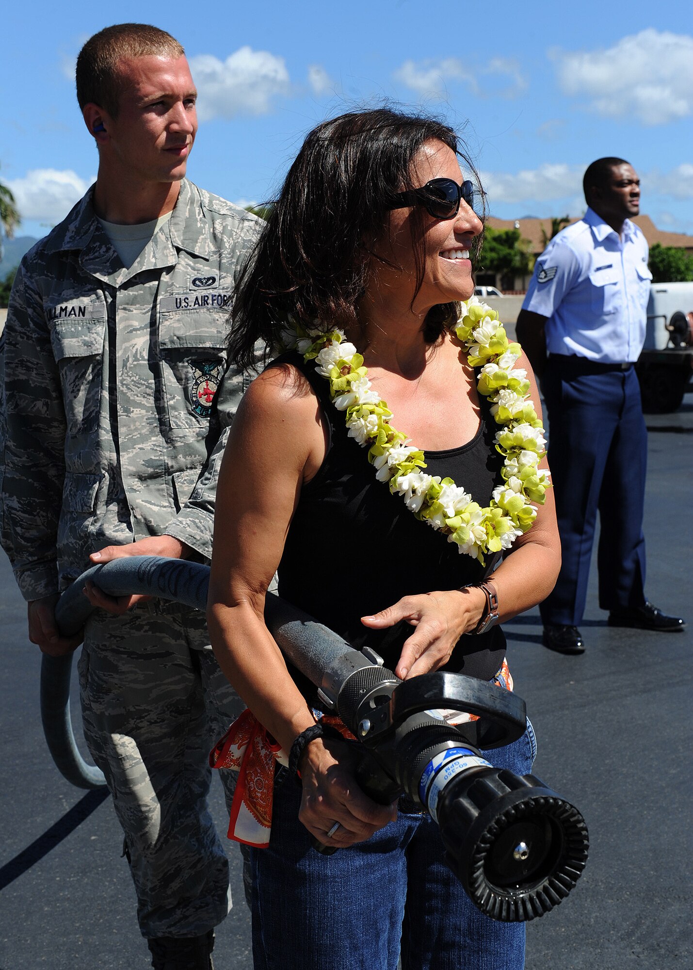 Staff Sgt. Gregory L. Ullman, 647th Civil Engineer Squadron fire protection journeyman, and Mrs. Marie Mclean, spouse of Chief Master Sgt. Brooke McLean, Pacific Air Forces command chief, wait for the Chief to debark a C-40B/C Clipper so she can hose him down after completing his "fini-flight" and arriving at the flight line at Joint Base Pearl-Harbor-Hickam, Hawaii, Oct. 29, 2012. McLean served 30 years in the Air Force and will retire Nov. 16, 2012 at JBPH-H, Hawaii. (U.S. Air Force photo/Tech. Sgt. Jerome S. Tayborn)