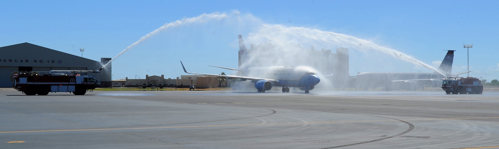 A C-40B/C Clipper is hosed down as it passes by two Joint Base Pearl Harbor-Hickam fire trucks on the flight line at JBPH-H, Hawaii, Oct. 29, 2012. The aircraft carried Gen. Herbert J. “Hawk” Carlisle, Pacific Air Forces commander, and Chief Master Sgt. Brooke McLean, PACAF command chief, marks Chief McLean’s last trip as PACAF top enlisted leadership. McLean served 30 years in the Air Force and will retire Nov. 16, 2012.  (U.S. Air Force photo/Tech. Sgt. Jerome S. Tayborn)