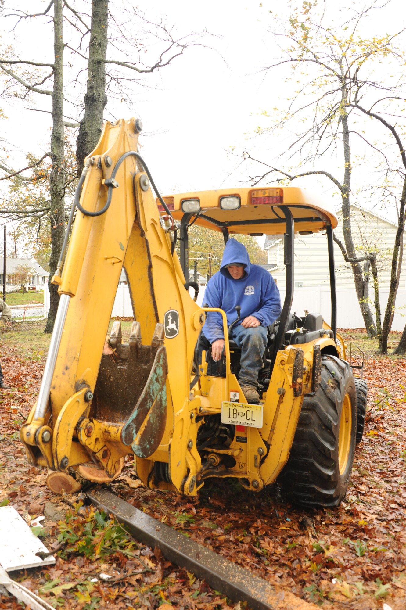 Matt Garron, United Communities Housing Office maintainer, uses a backhoe to remove Hurricane Sandy wreckage Oct. 30 in Falcon Courts North. Security forces, civil engineers and emergency management were some of the first responders to take on the task of getting the base back to normal operations. (U.S. Air Force photo by Airman Sean Crowe/Released) 