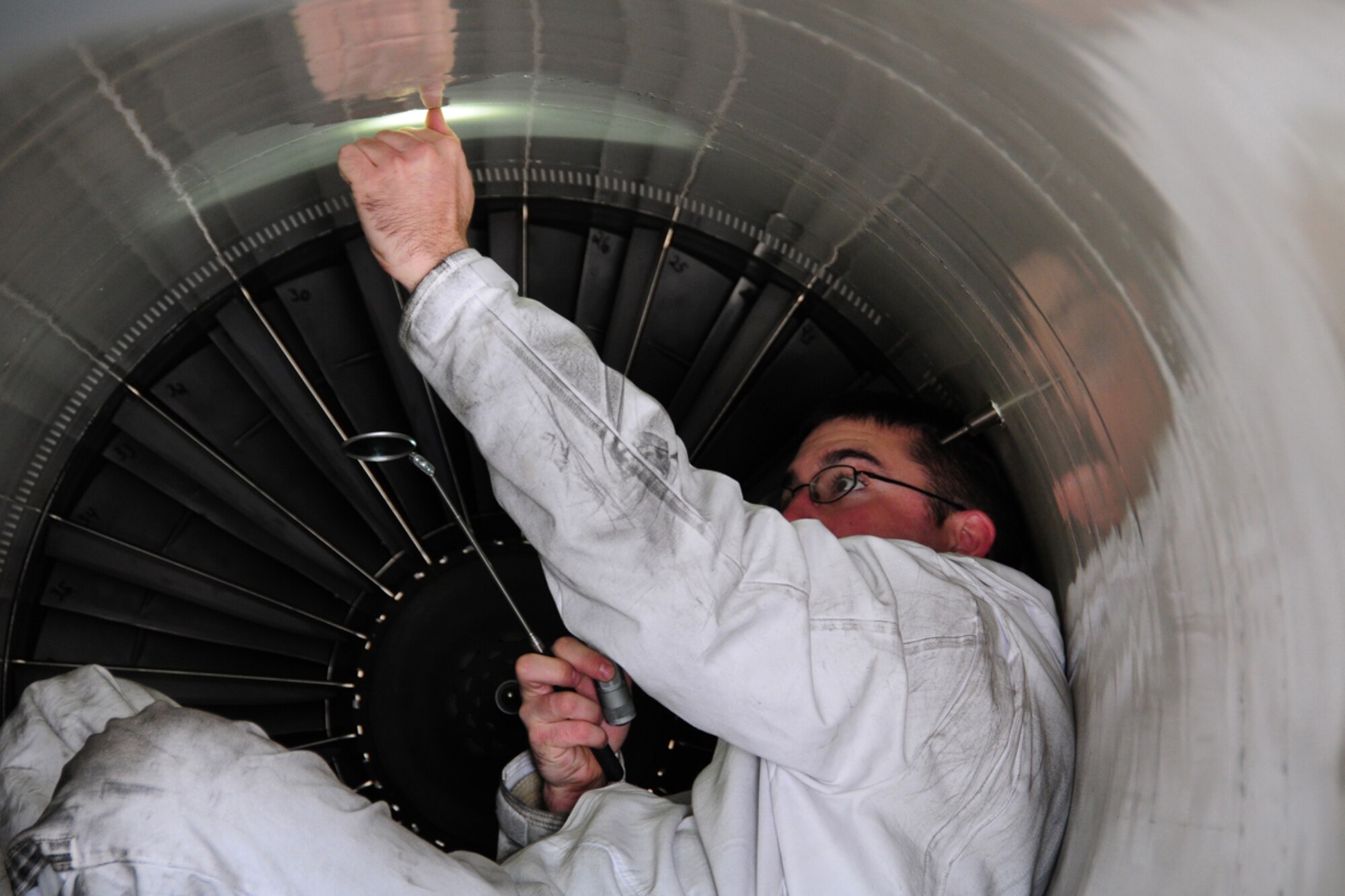 JOINT BASE ELMENDORF-RICHARDSON -- Staff Sgt. Brandon Deem, 44th Expeditionary Aircraft Maintenance Unit, inspects rivets in the #1 engine intake of an F-15C Eagle. Airmen, aircraft, and equipment from Kadena Air Base, Japan, are deployed to Joint Base Elmendorf-Richardson supporting the Alaskan NORAD Region, part of the North American Aerospace Defense Command mission providing aerospace warning and control for North America. (U.S. Air Force photo/Master Sgt. Mikal Canfield)