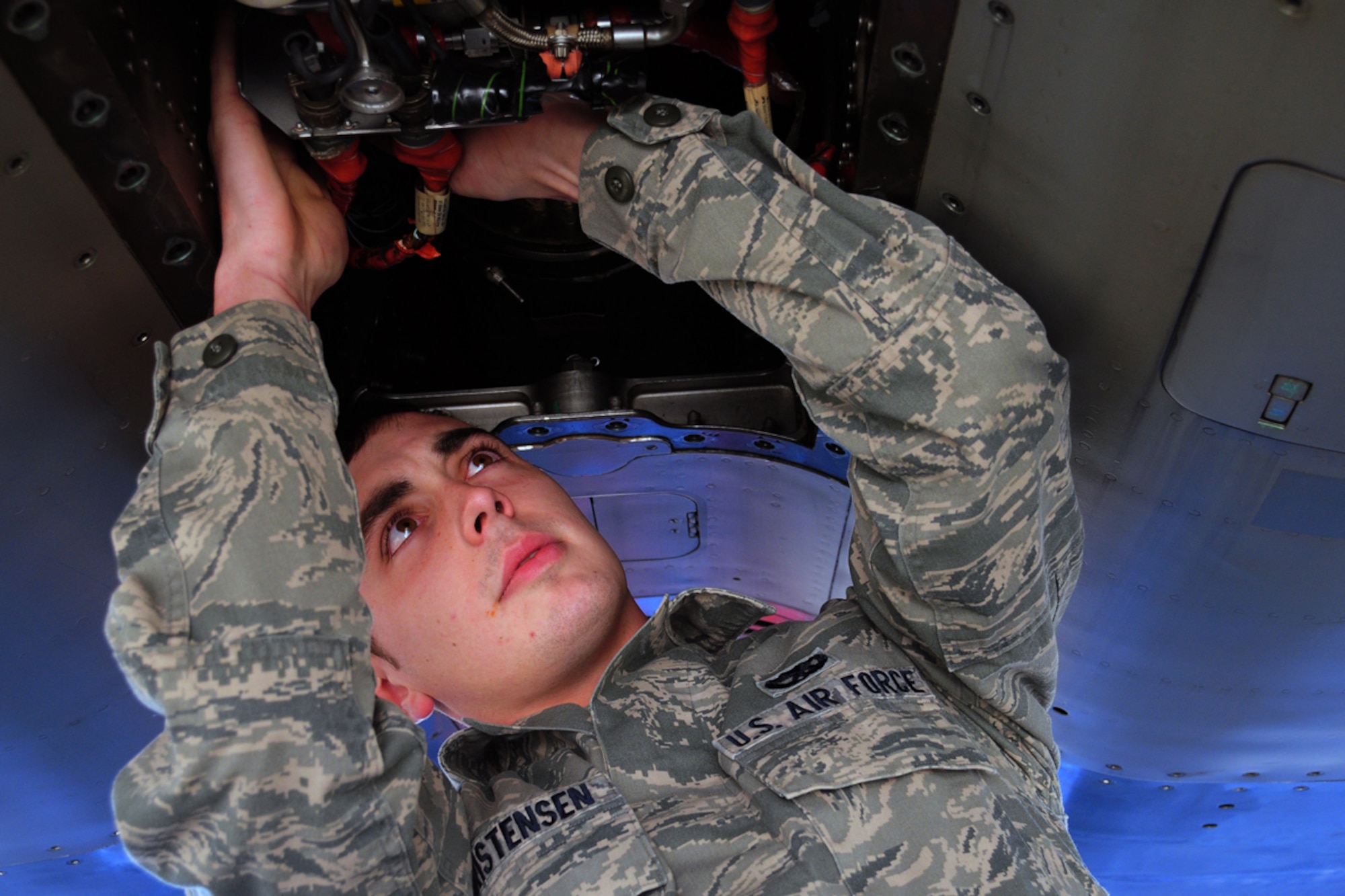 JOINT BASE ELMENDORF-RICHARDSON -- Senior Airman Devon Christensen, 44th Expeditionary Aircraft Maintenance Unit, inspects fuel hose connections on the jet fuel starter (JFS) of an F-15C Eagle. Airmen, aircraft, and equipment from Kadena Air Base, Japan, are deployed to Joint Base Elmendorf-Richardson supporting the Alaskan NORAD Region, part of the North American Aerospace Defense Command mission providing aerospace warning and control for North America. (U.S. Air Force photo/Master Sgt. Mikal Canfield)