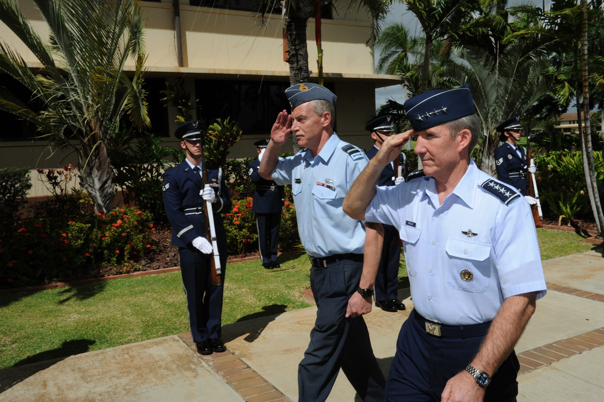 Air Vice Marshal Peter Stockwell, Chief of Air Force, Royal New Zealand Air Force, and Gen. Herbert J. “Hawk” Carlisle, Pacific Air Forces commander, salute as they pass through the Joint Base Pearl Harbor-Hickam honor guard cordon at the Pacific Air Forces Headquarters building, Joint Base Pearl Harbor-Hickam, Hawaii, Oct. 30, 2012. Air Vice Marshal Stockwell visited Hawaii to meet with Gen. Carlisle and senior leaders of PACAF to discuss common concerns and explore opportunities to strengthen regional cooperation. (U.S. Air Force photo/Tech. Sgt. Jerome S. Tayborn/Released)