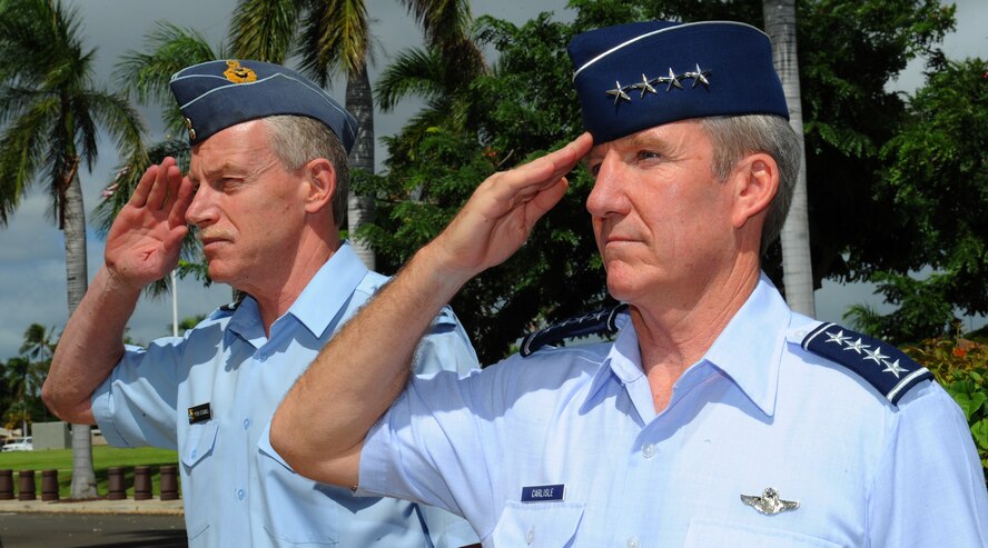 Air Vice Marshal Peter Stockwell, Chief of Air Force, Royal New Zealand Air Force, and Gen. Herbert J. “Hawk” Carlisle, Pacific Air Forces commander, render salutes prior to passing through the Joint Base Pearl Harbor-Hickam honor guard cordon at the Pacific Air Forces Headquarters building, Joint Base Pearl Harbor-Hickam, Hawaii, Oct. 30, 2012. Air Vice Marshal Stockwell visited Hawaii to meet with Gen. Carlisle and senior leaders of PACAF to discuss common concerns and explore opportunities to strengthen regional cooperation. (U.S. Air Force photo/Tech. Sgt. Jerome S. Tayborn/Released)