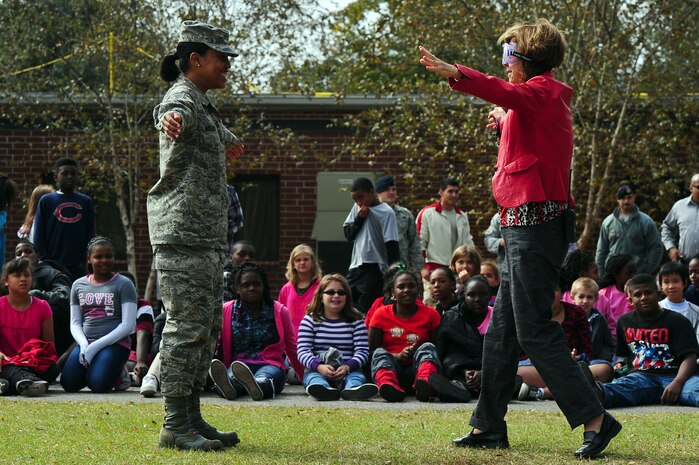 Staff Sgt. Samantha McLeod, 315th Aerospace Medicine Squadron Drug Testing Program administrative manager, shows a volunteer where to walk during a demonstration for Red Ribbon Week Oct. 30, 2012, at Hunley Park Elementary School, North Charleston, S.C. The demonstration included a volunteer trying to walk with goggles that gave the appearance of an impaired individual. The campaign began  after the 1985 murder of Federal Drug Enforcement Administration Agent, Enrique Camarena, while he was investigating Mexican drug traffickers. Red Ribbon Week allows educators, parents, community groups, students and others to focus on the work being done by the many who have pledged to live drug free. (U.S. Air Force photo/ Airman 1st Class Chacarra Walker)